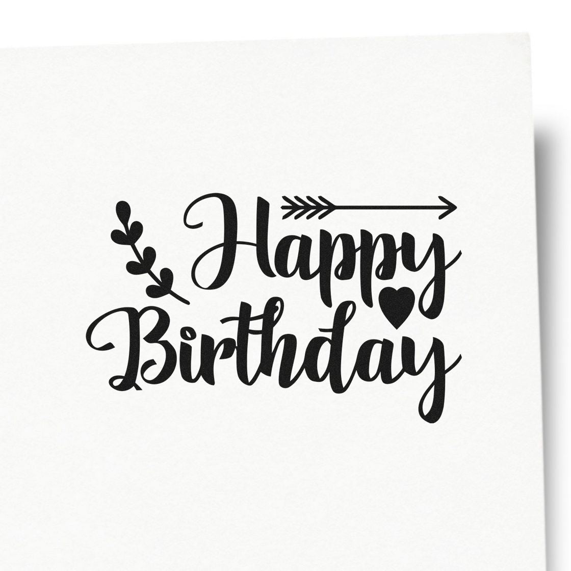 Black Happy Birthday stamp and seal with arrow, heart, and leafy accents on a white background