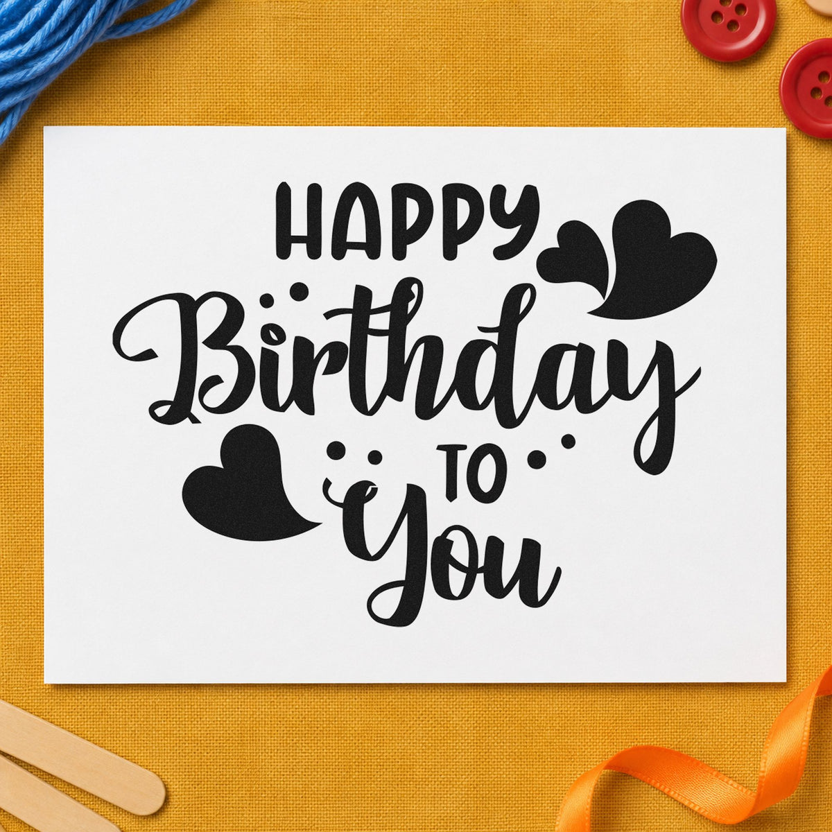 Happy Birthday To You craft stamp imprint in black ink on a handmade project, one idea being separate gift tags.