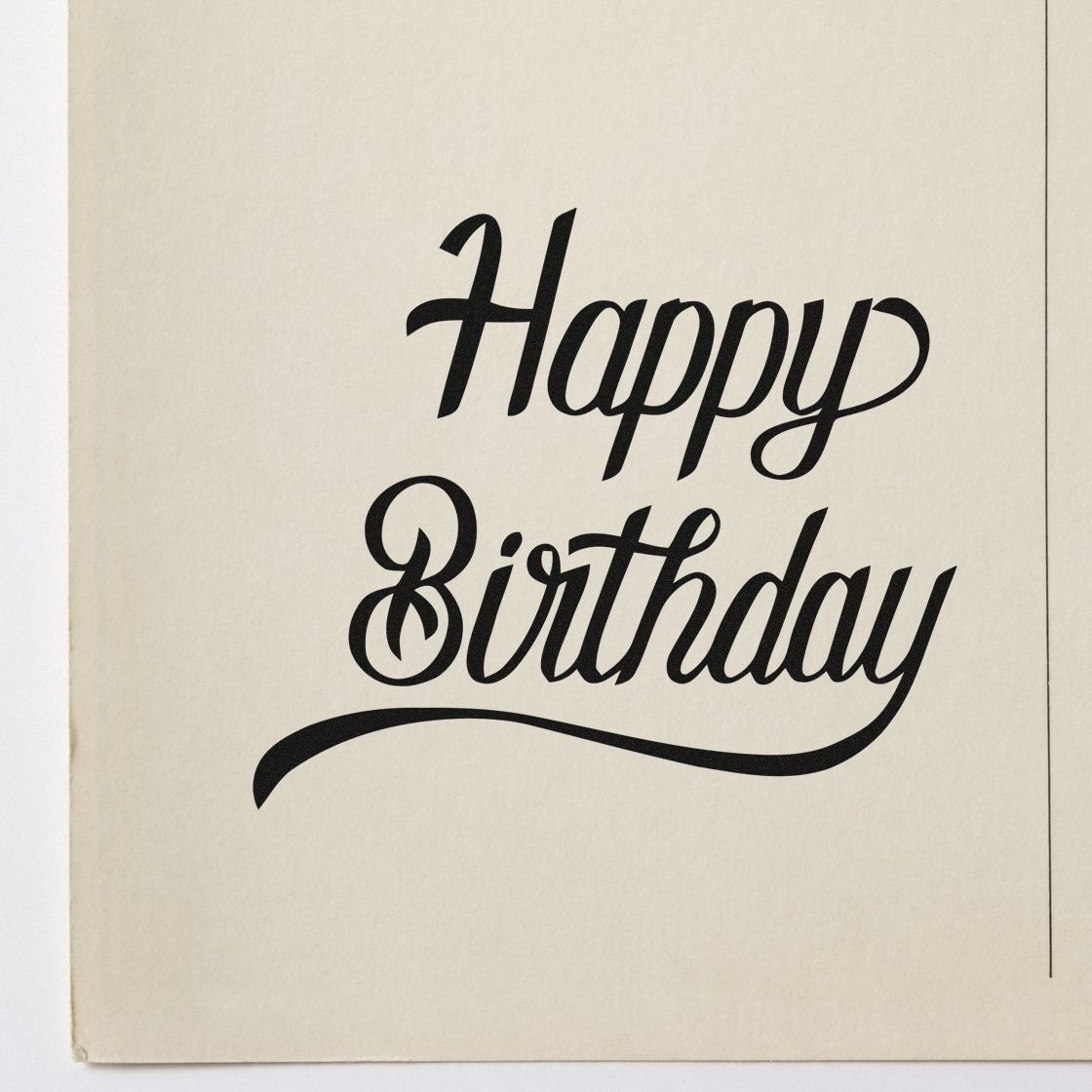 Black Happy Birthday calligraphy stamp on cream paper, with flowing script and decorative underline for stamp and seal products.