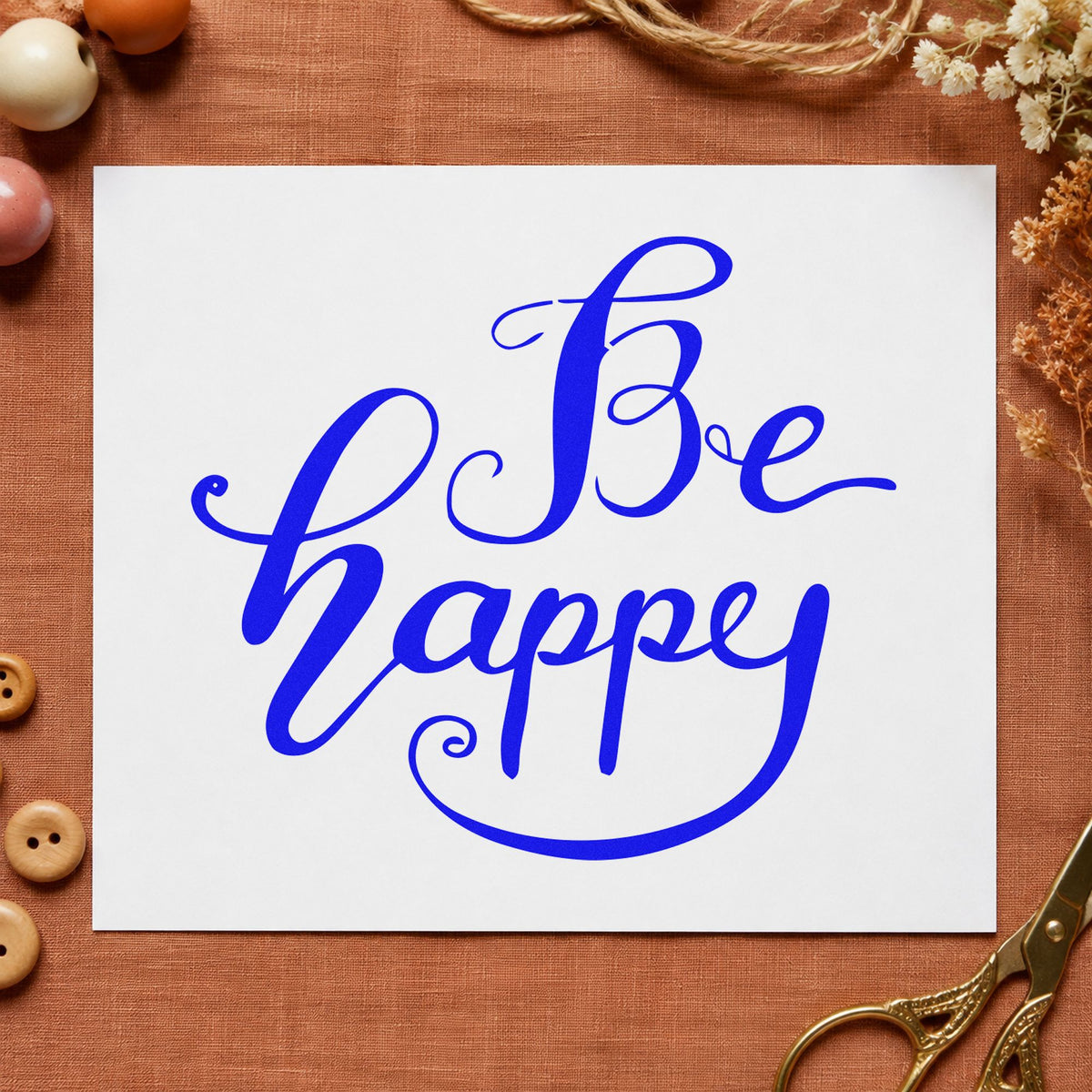 Be Happy Flowing Script craft stamp imprinted in blue ink on paper, a design suited to framed bath shelf.