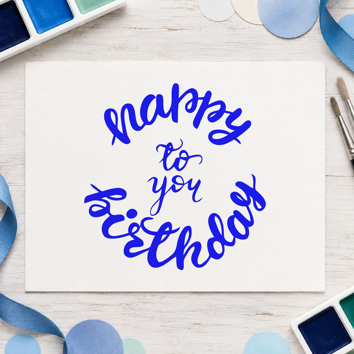 Happy Birthday Circular Script craft stamp in blue ink on cardstock, an easy option for bar towel printing.