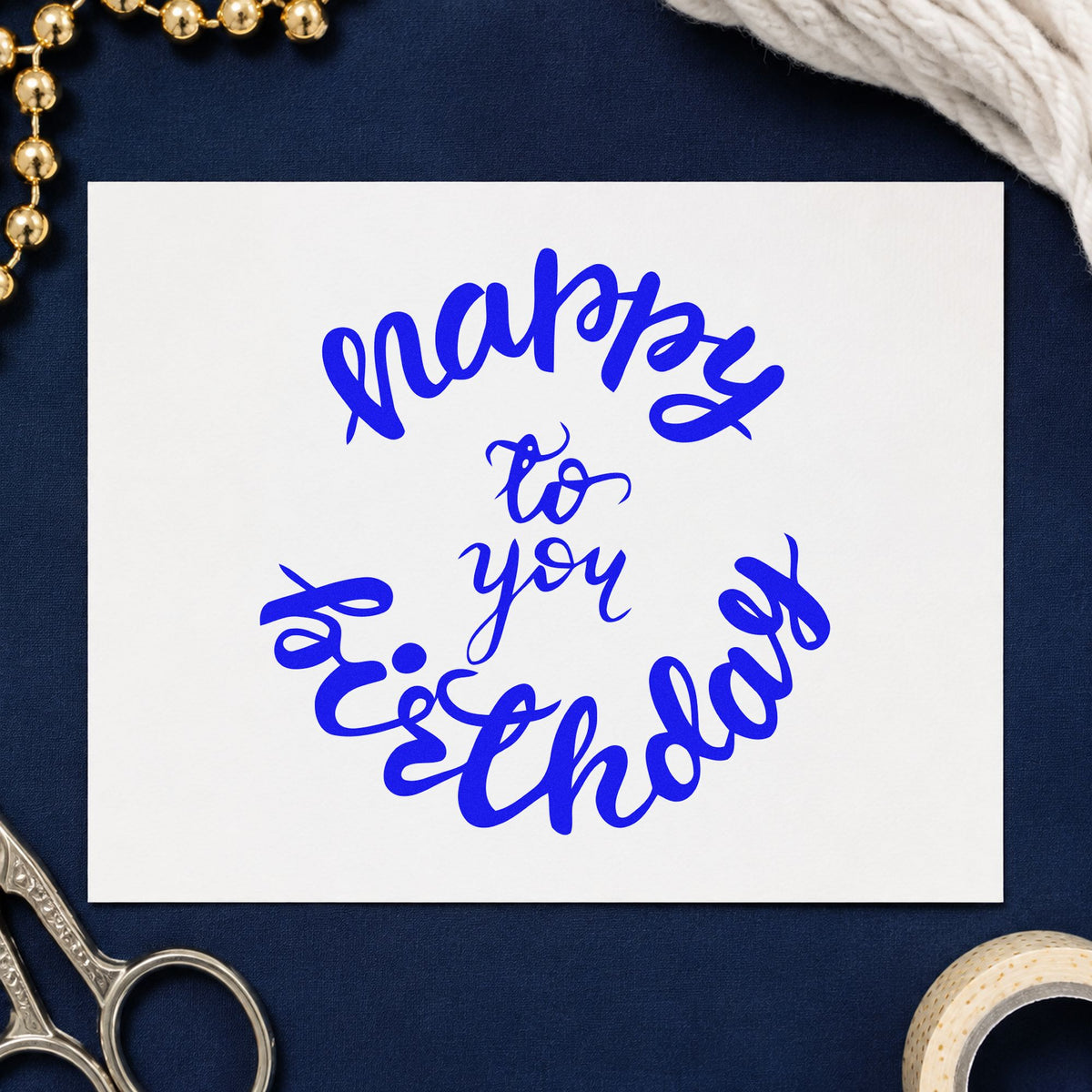 Happy Birthday Circular Script craft stamp imprinted in blue ink on paper, a design suited to framed snug corner.
