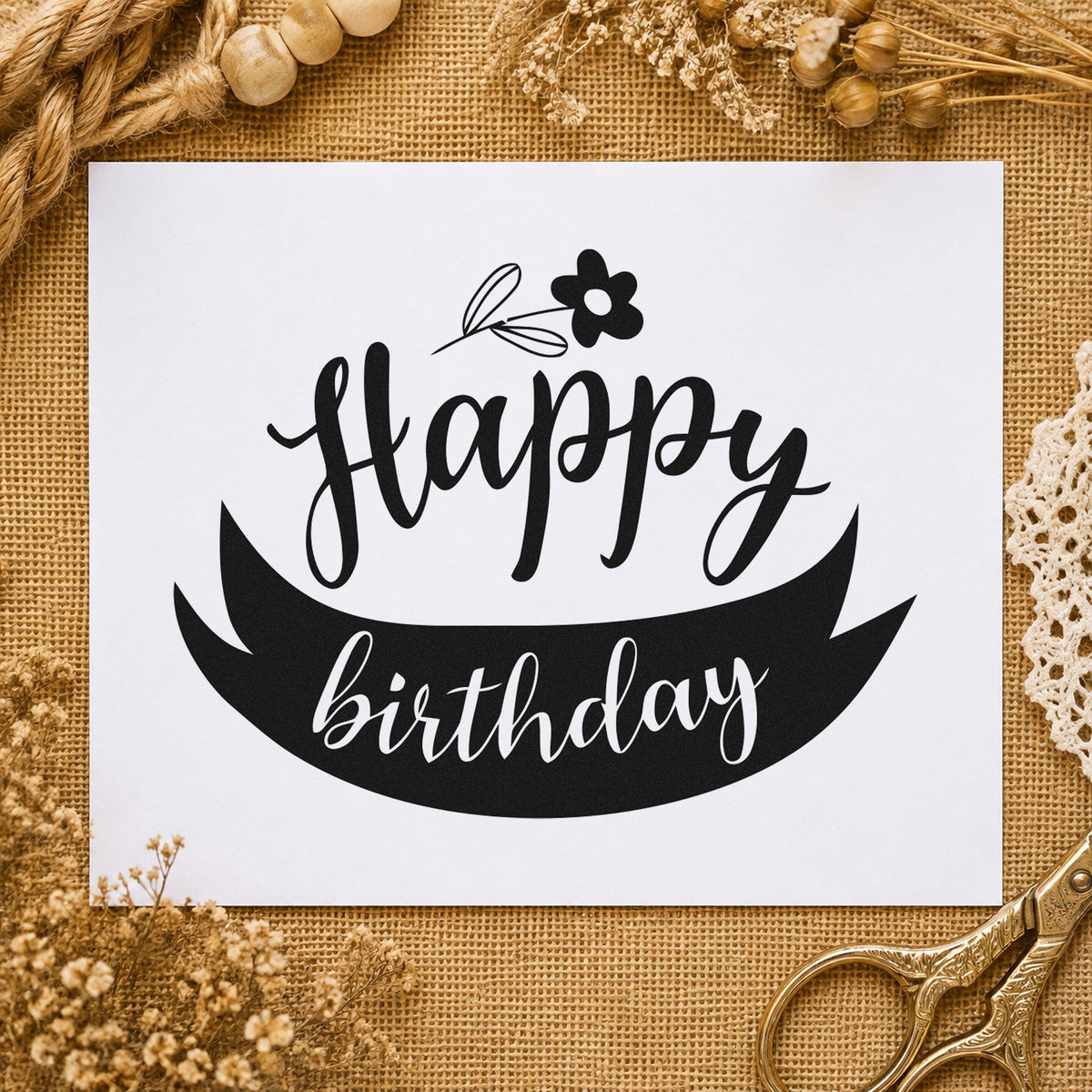 Happy Birthday Flower Ribbon craft stamp imprint in black ink on a handmade project, one idea being stem wrap gift tags.