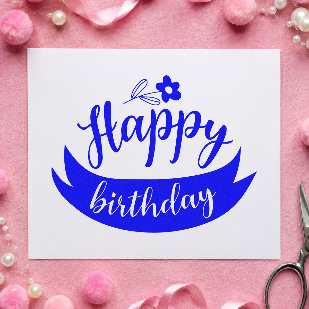 Happy Birthday Flower Ribbon craft stamp imprinted in blue ink on paper, a design suited to framed potting bench.