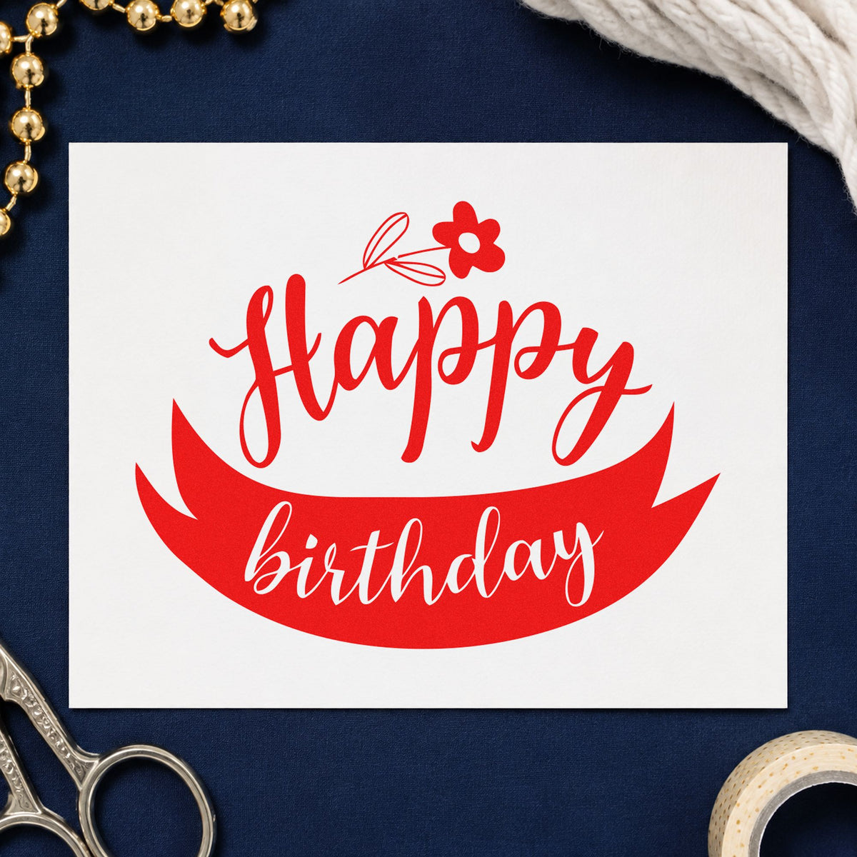 Happy Birthday Flower Ribbon craft stamp imprint in red ink on a handmade project, one idea being care note cards.