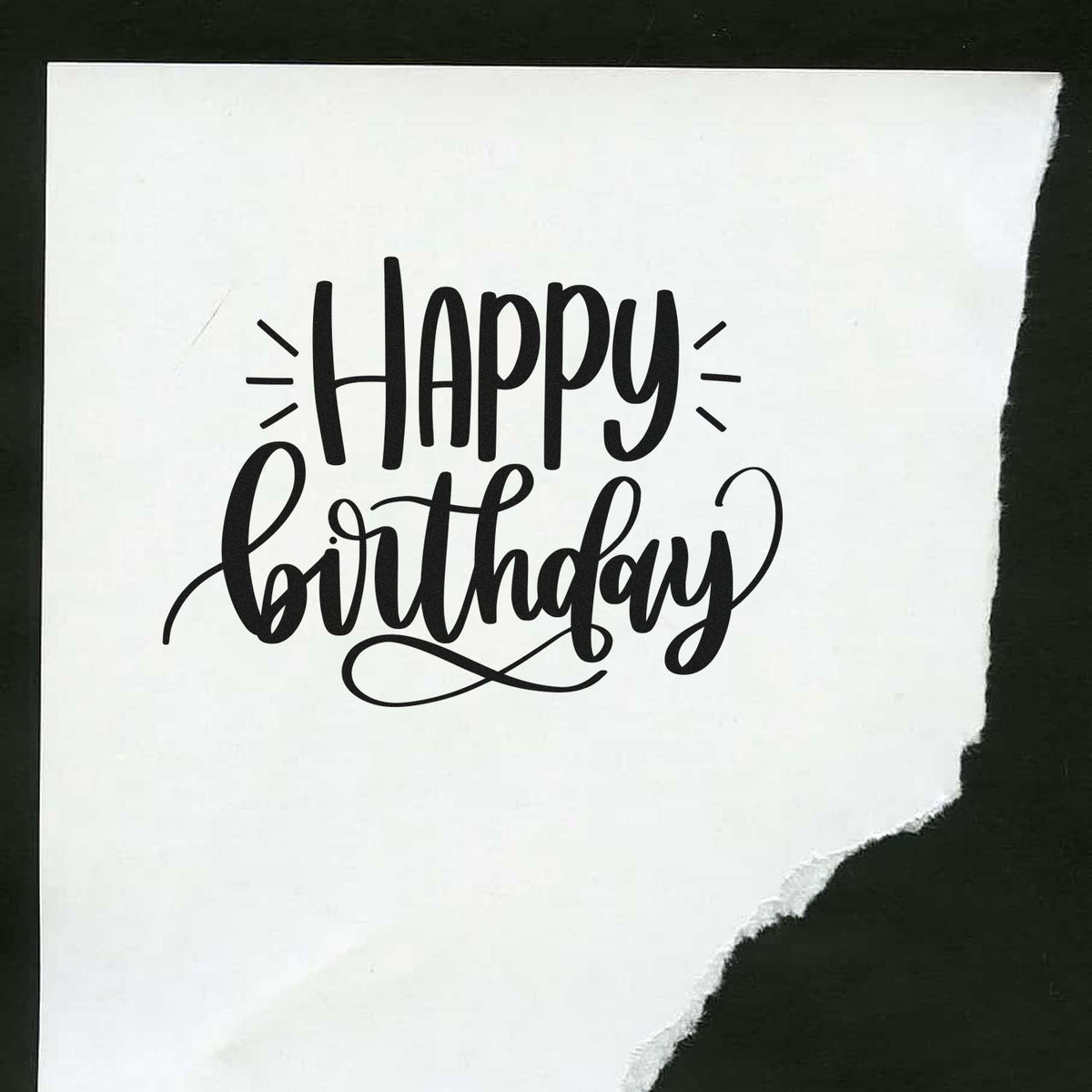 Black Happy Birthday stamp seal on white torn paper, with decorative script and black background.