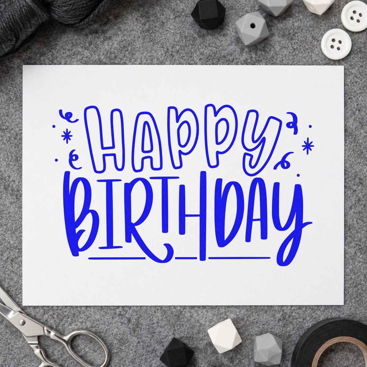 Outlined Happy Birthday Confetti craft stamp in blue ink on cardstock, an easy option for packing cloth printing.