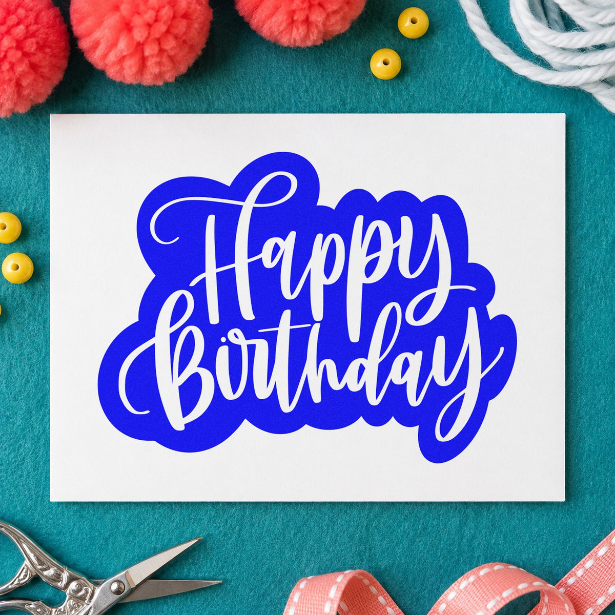 Birthday White Script Silhouette craft stamp in blue ink on cardstock, an easy option for bench cloth printing.