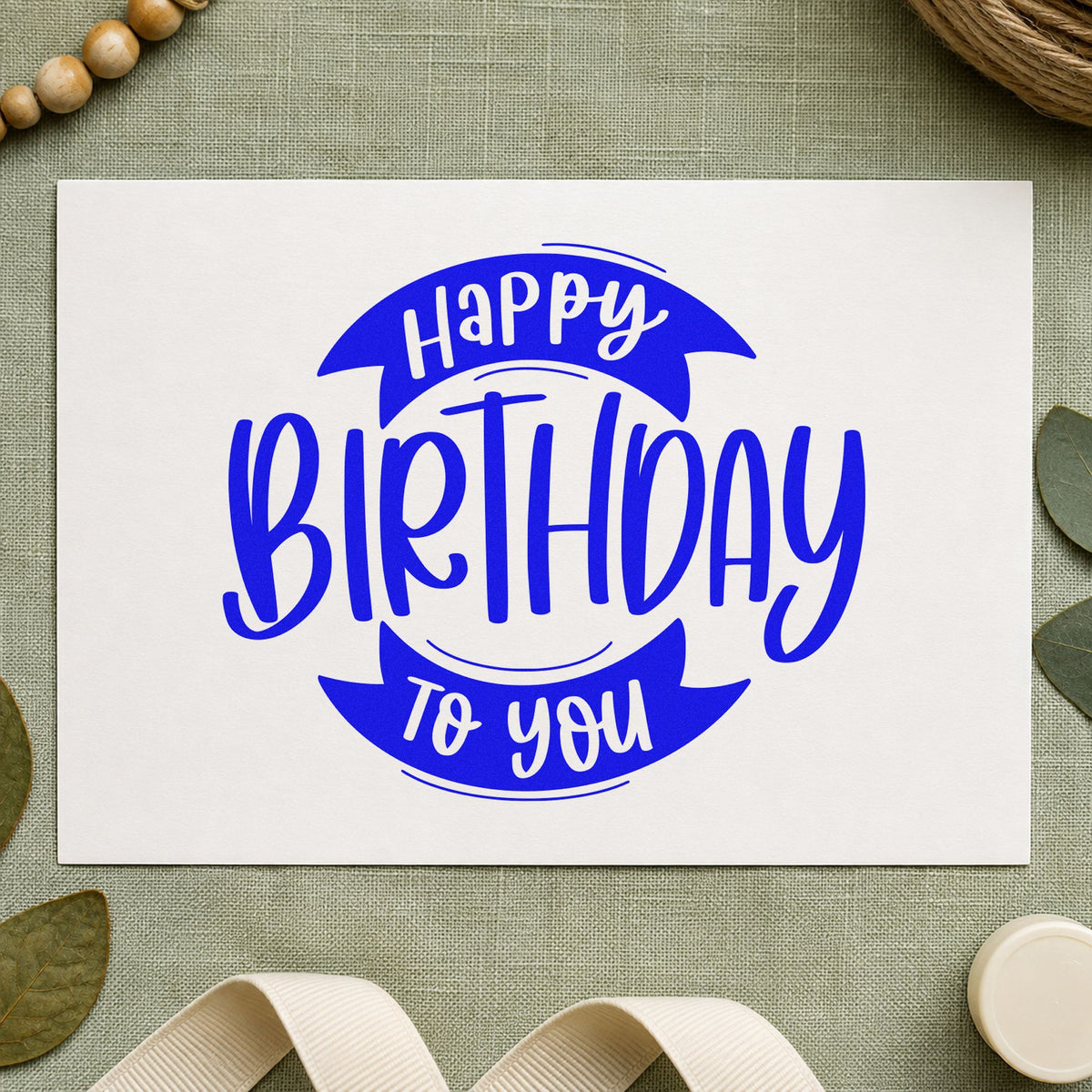 Birthday To You Ribbon craft stamp imprinted in blue ink on paper, a design suited to framed hall shelf.