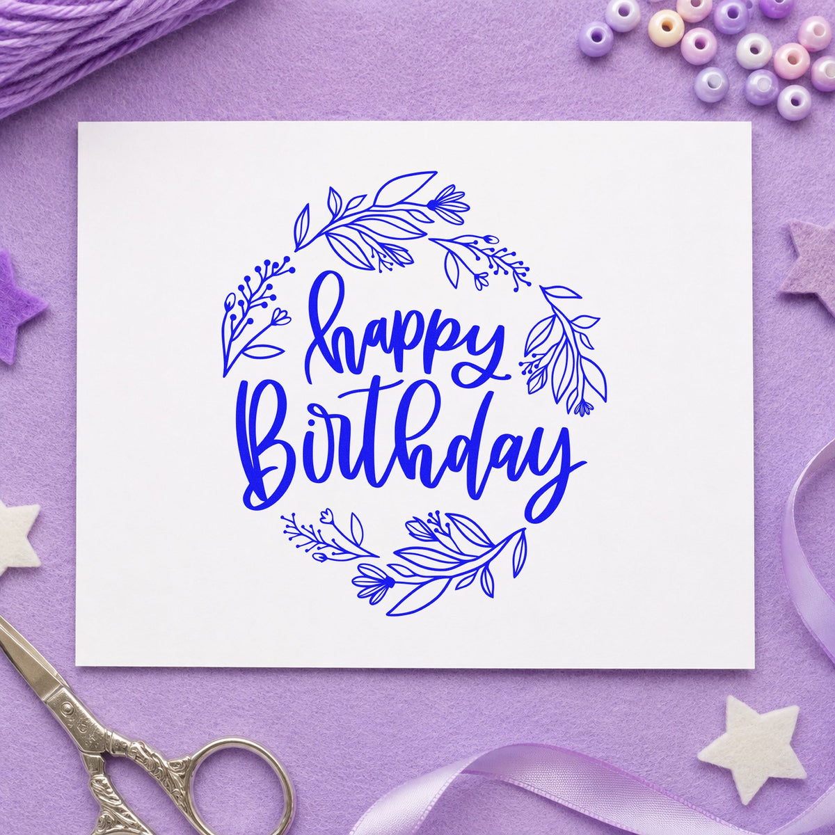 Happy Birthday Leafy Wreath craft stamp in blue ink on cardstock, an easy option for mat bag printing.