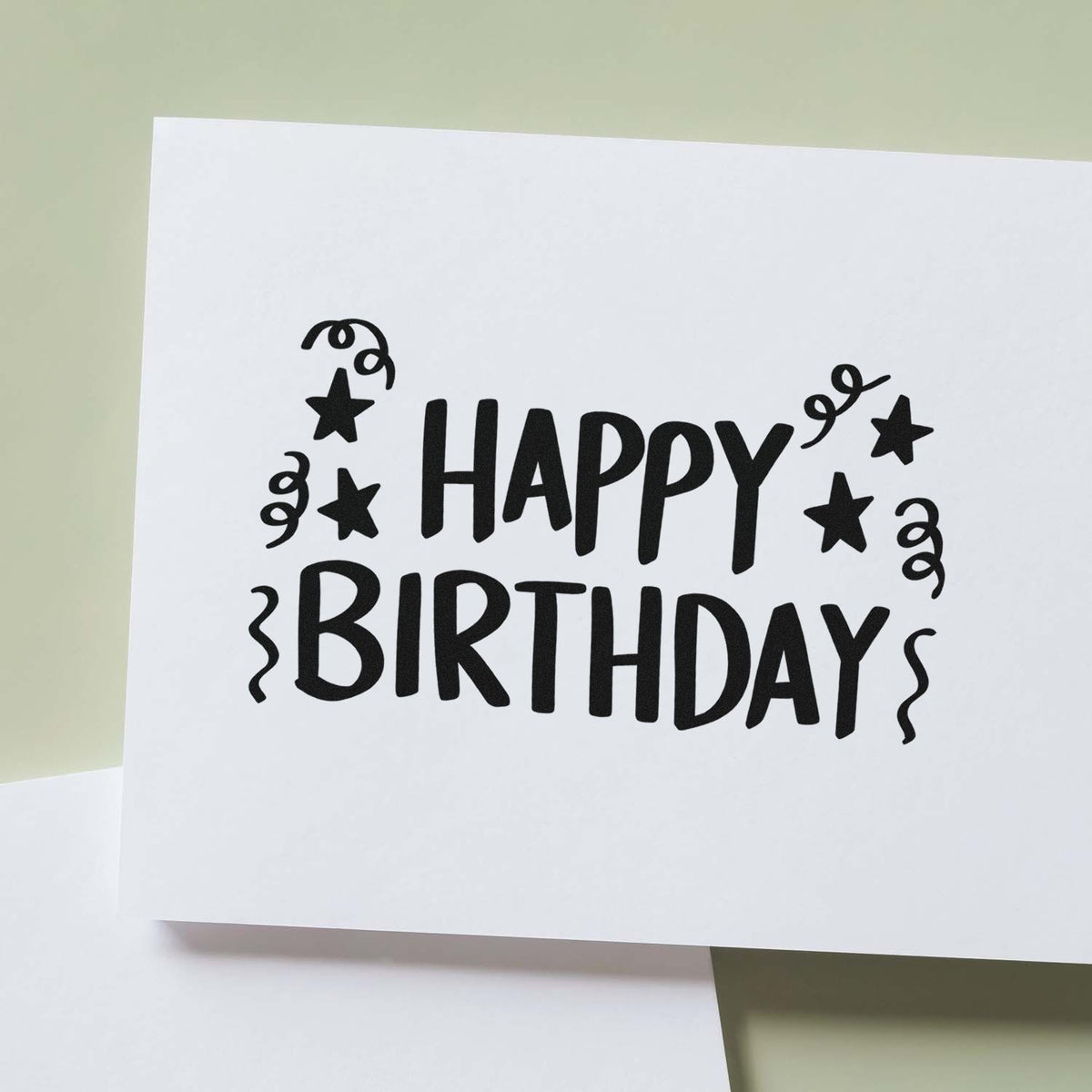 Black Happy Birthday stamp with stars and confetti on white card, a stamp and seal product.