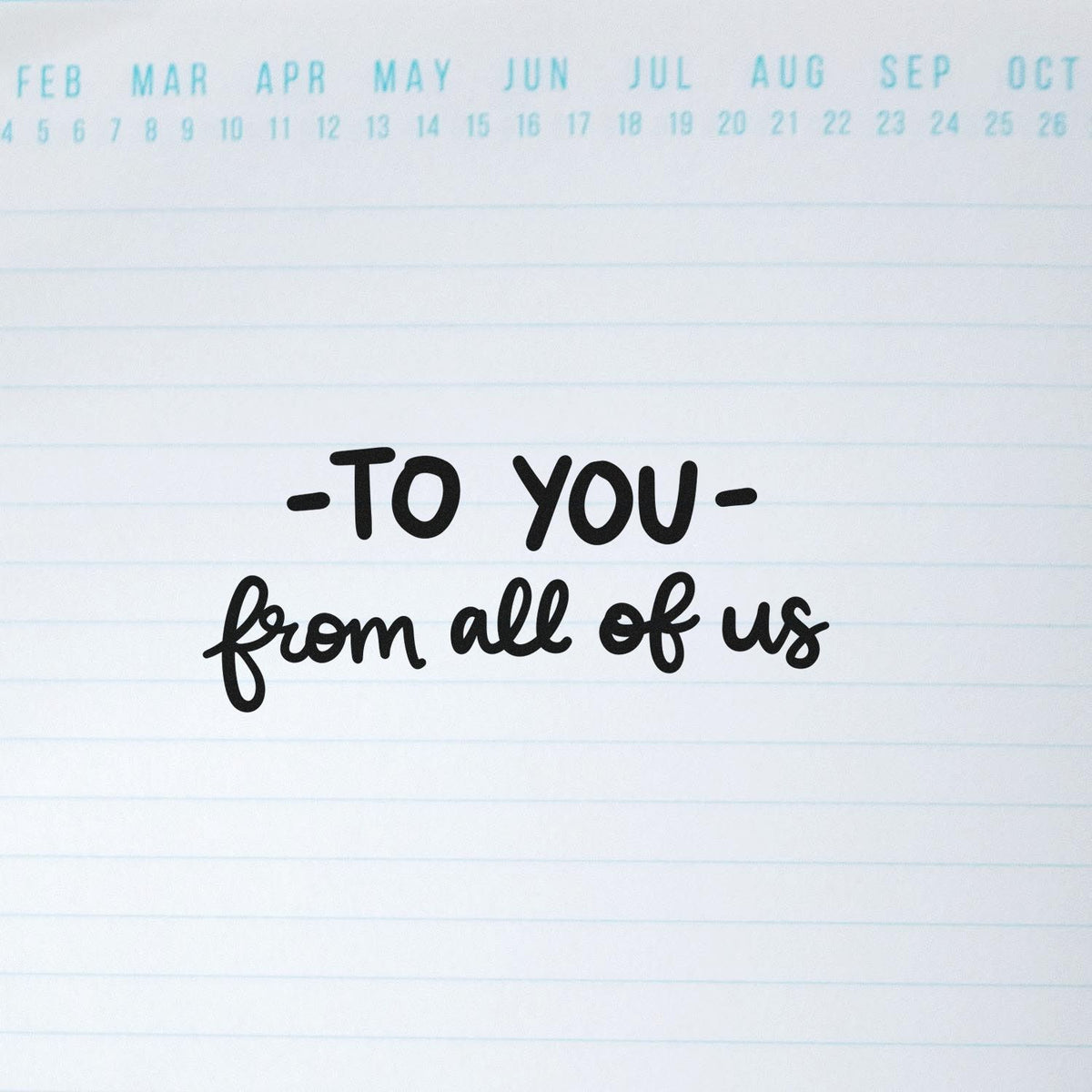 Black decorative stamp reading To you from all of us on white lined paper with pale blue calendar header.