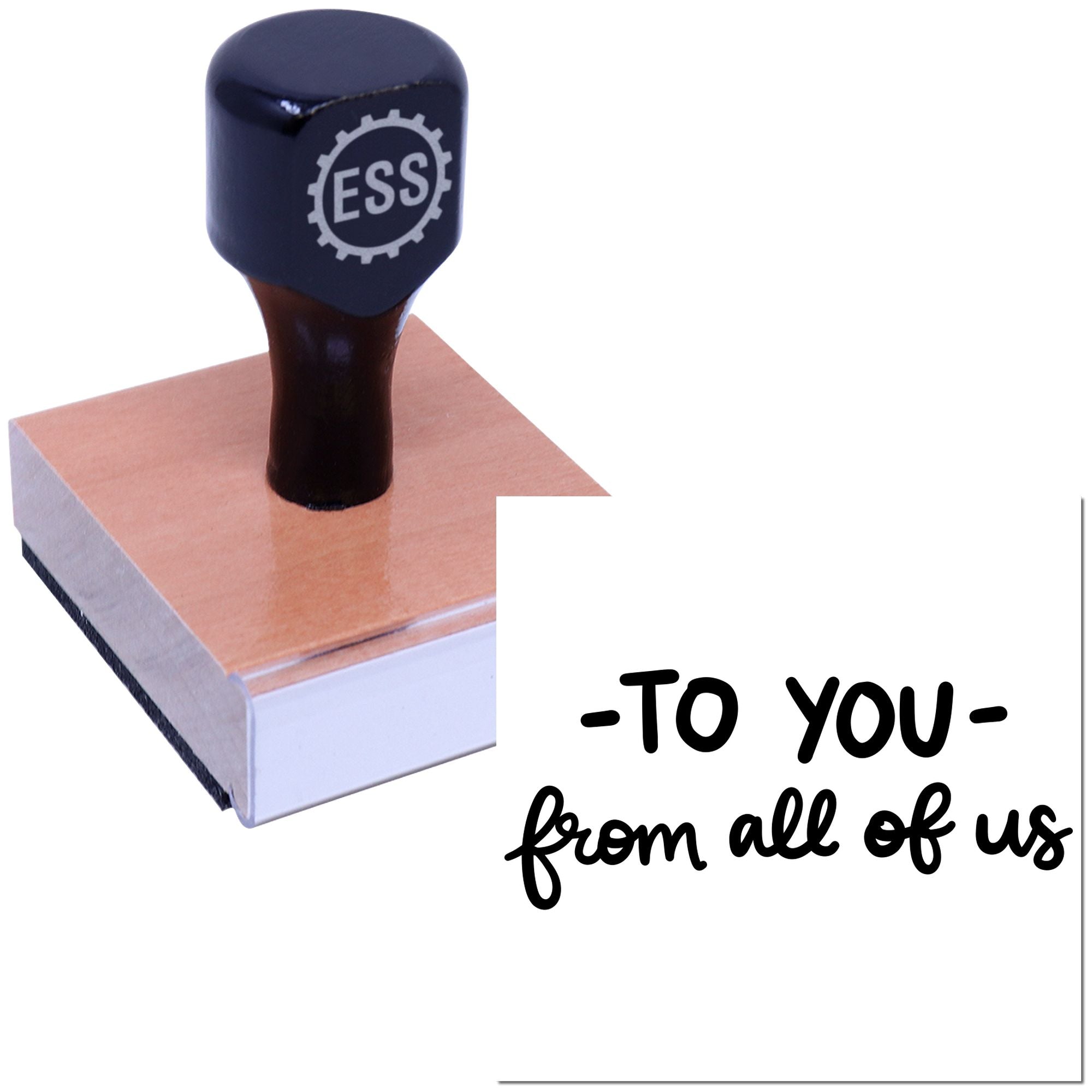 Black ESS rubber stamp and seal on pink wooden block, with -To YOU- from all of us on white background.