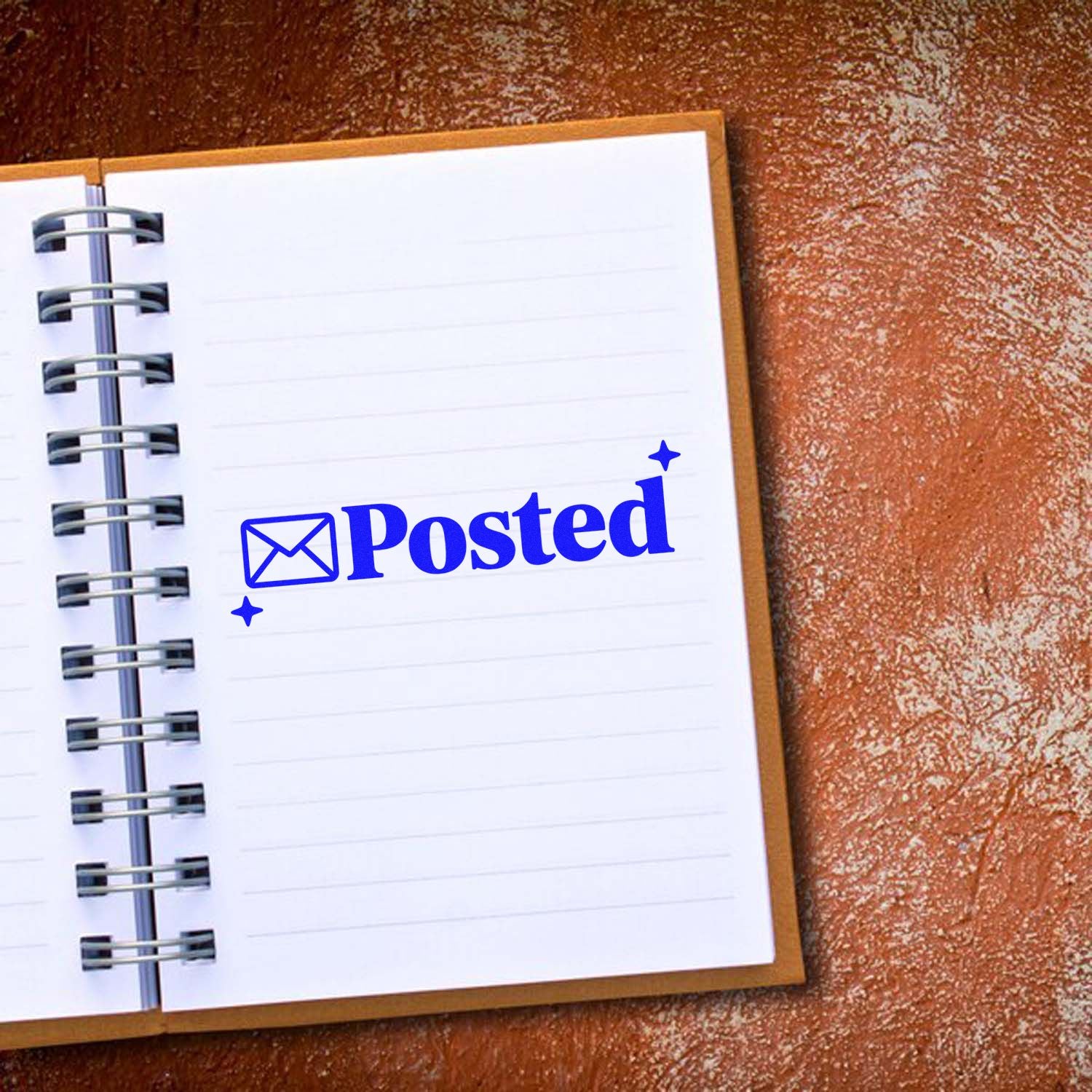 Blue Posted stamp seal with envelope icon on a white spiral notebook over a brown textured background.