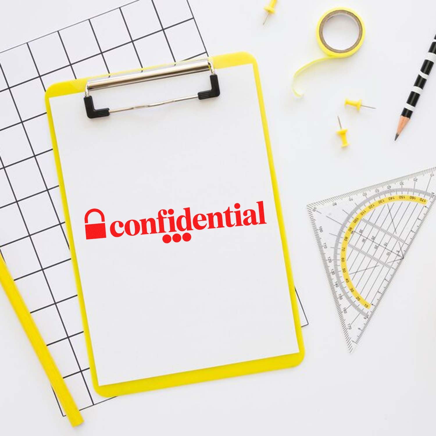 Yellow clipboard with red confidential stamp, black grid paper, ruler, pencil, and seal tape on white background.