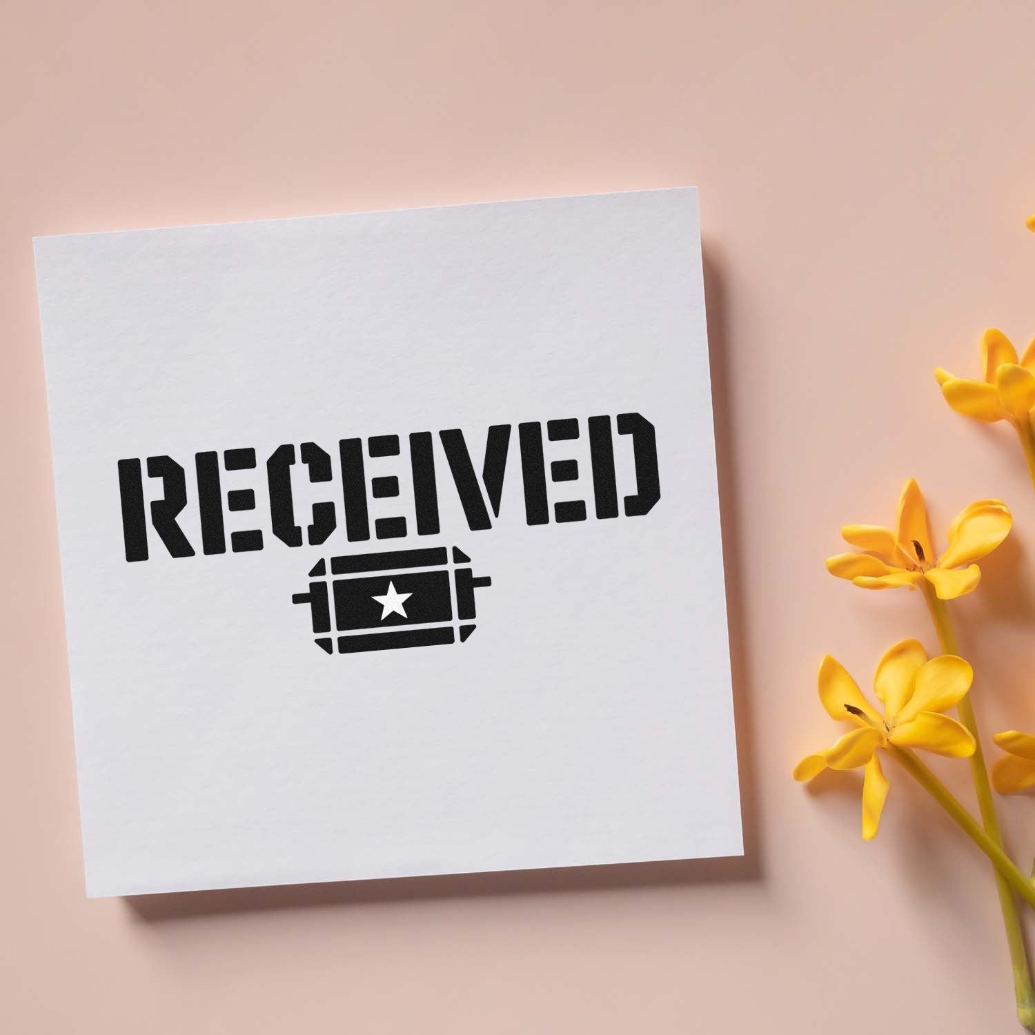 Bold black RECEIVED stamp and seal on white card, blush background, with yellow flowers.
