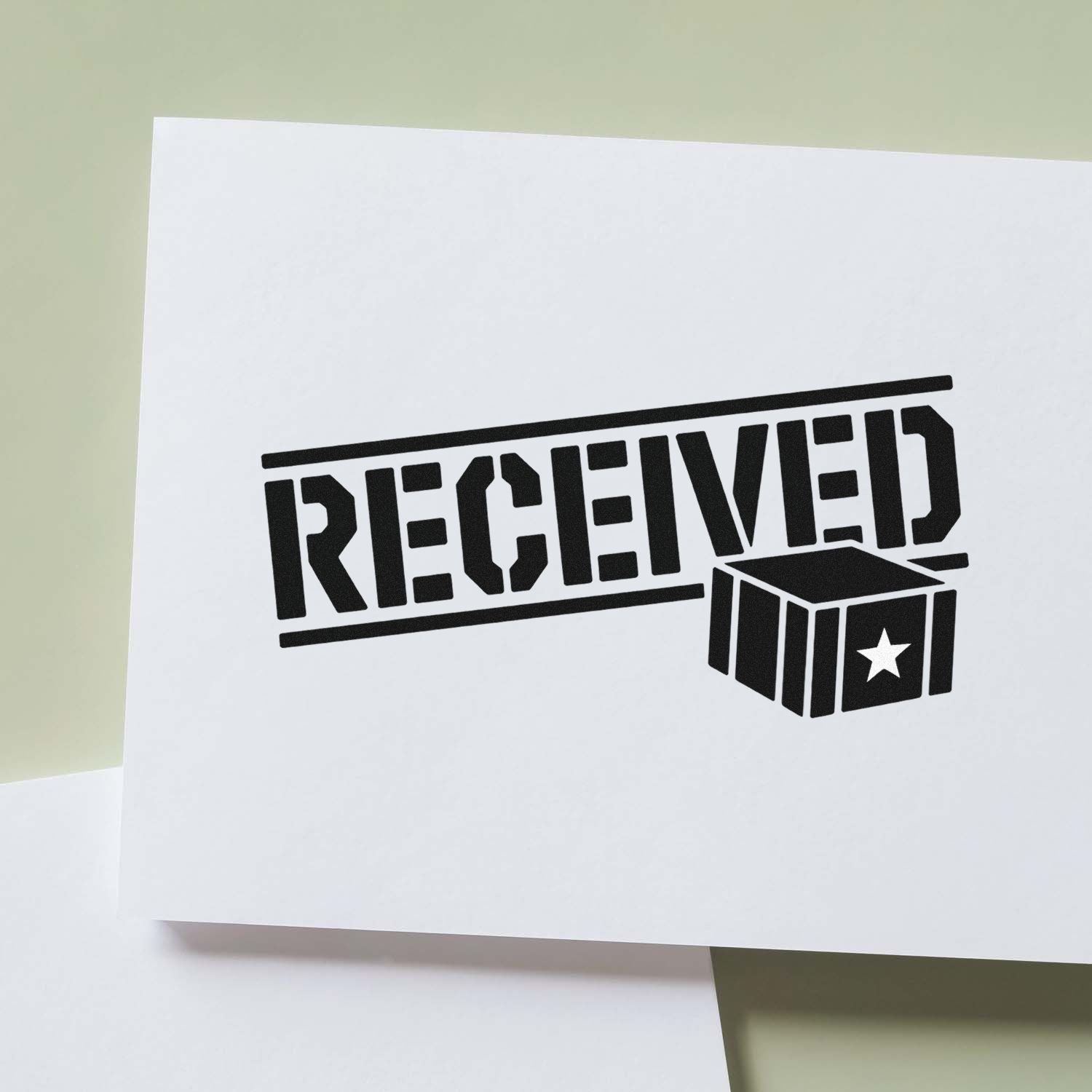 Black RECEIVED rubber stamp seal with box and star on white paper against a pale green background.