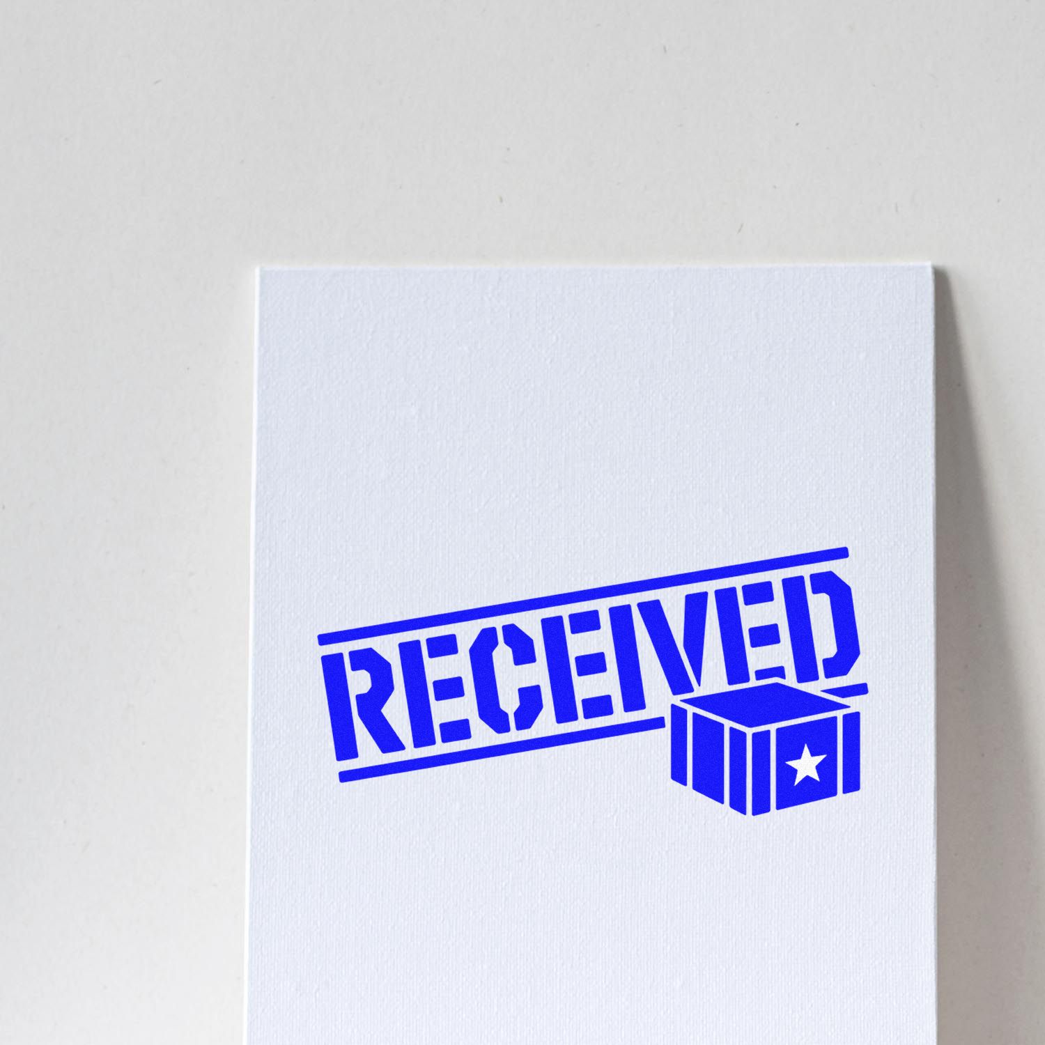 Blue RECEIVED stamp and seal imprint on white paper with cube seal icon and star.