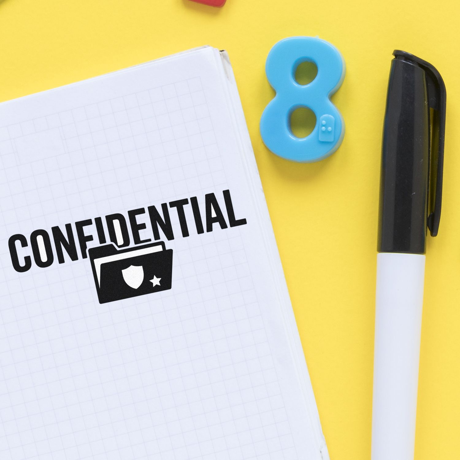 Confidential stamp seal products on yellow background with blue 8 seal, black-and-white marker, and notebook