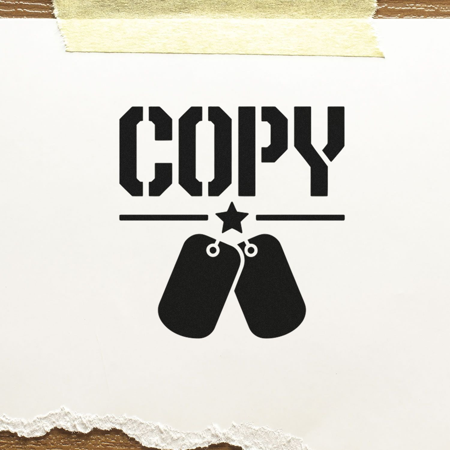 Black COPY stamp and seal design with dog tags and star on white paper, taped at top and torn at bottom.