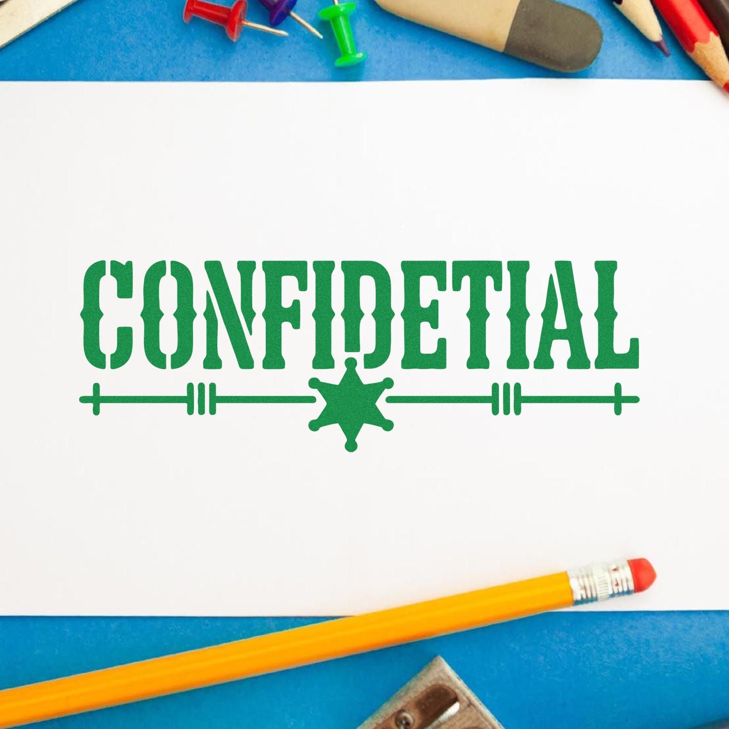 Green CONFIDENTIAL stamp and seal on white paper, with star emblem, blue background, and pencils.
