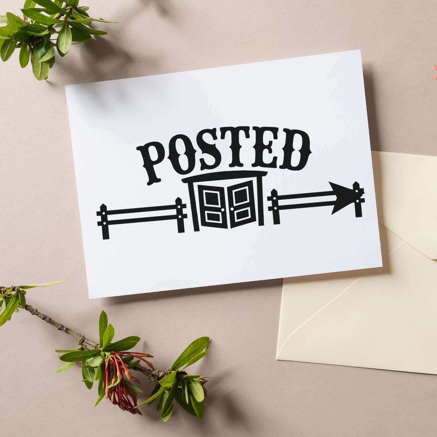 Black POSTED stamp and seal design with double doors and arrow on a white card, beside a cream envelope and green leaves.