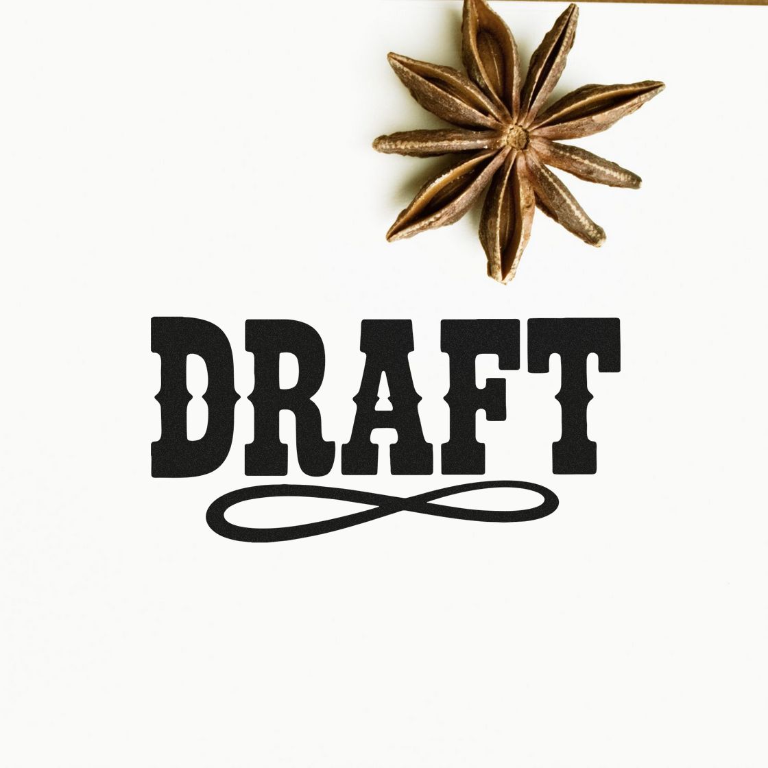 Black DRAFT stamp and seal with decorative flourish, topped by a brown star anise on a white background.