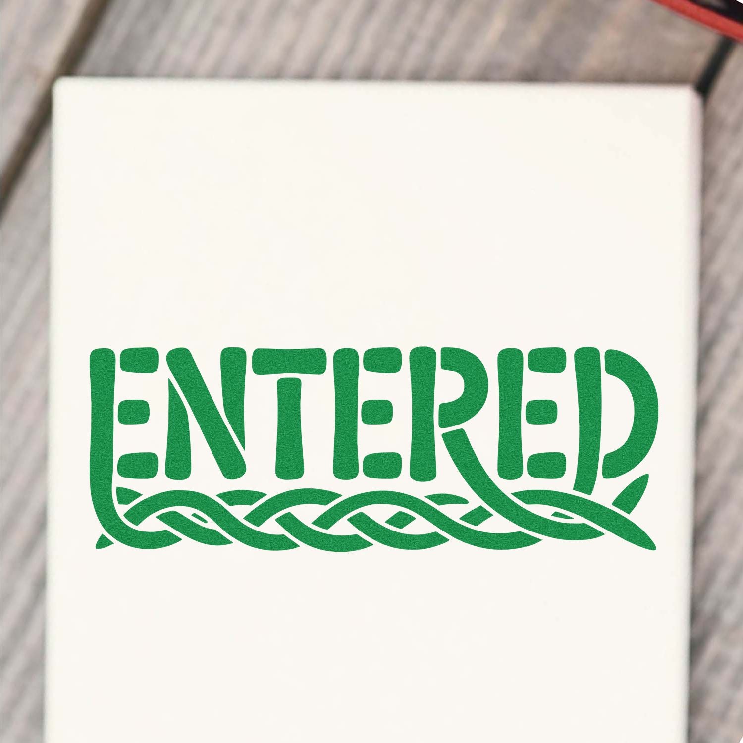 Green ENTERED stamp seal with braided knot design on white background.