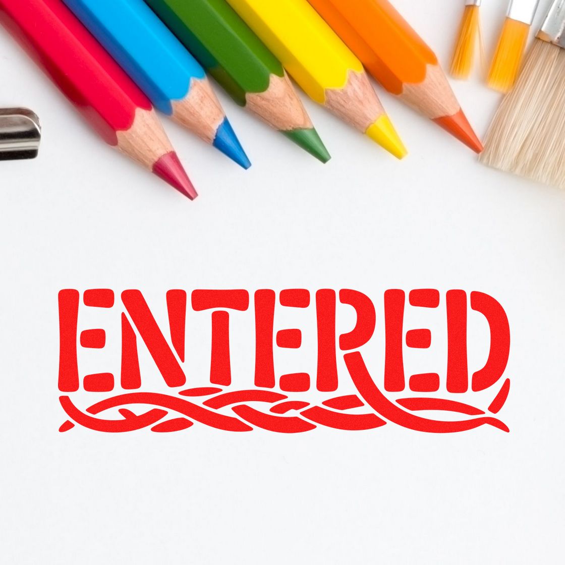 Red ENTERED stamp seal with colorful pencils and brushes on a white background