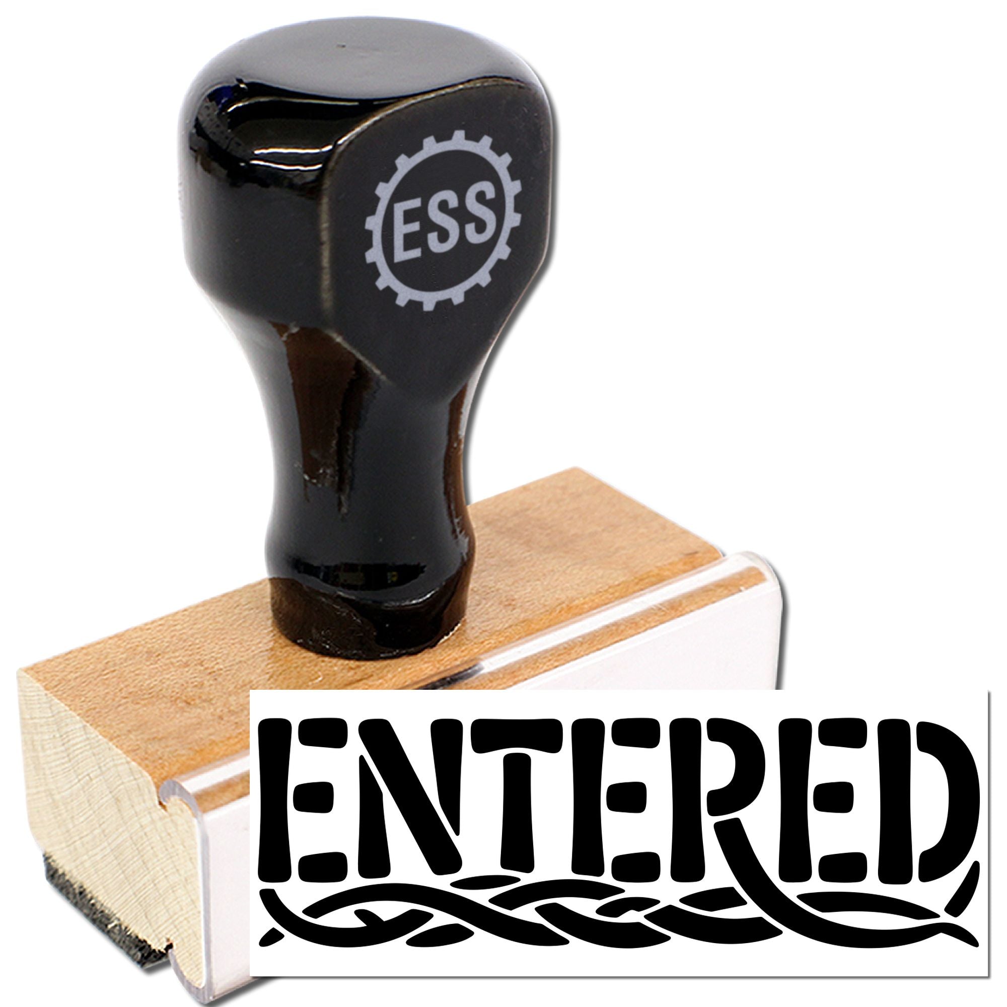 Black rubber stamp seal with ESS logo and ENTERED imprint on a wooden block, beside a white pad.