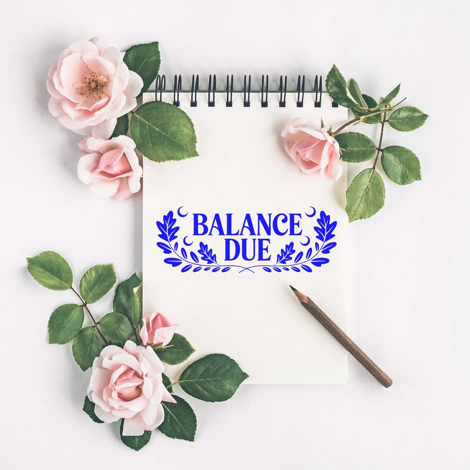 Blue BALANCE DUE stamp and seal on a white notebook page, framed by pink roses, green leaves, and a pencil.