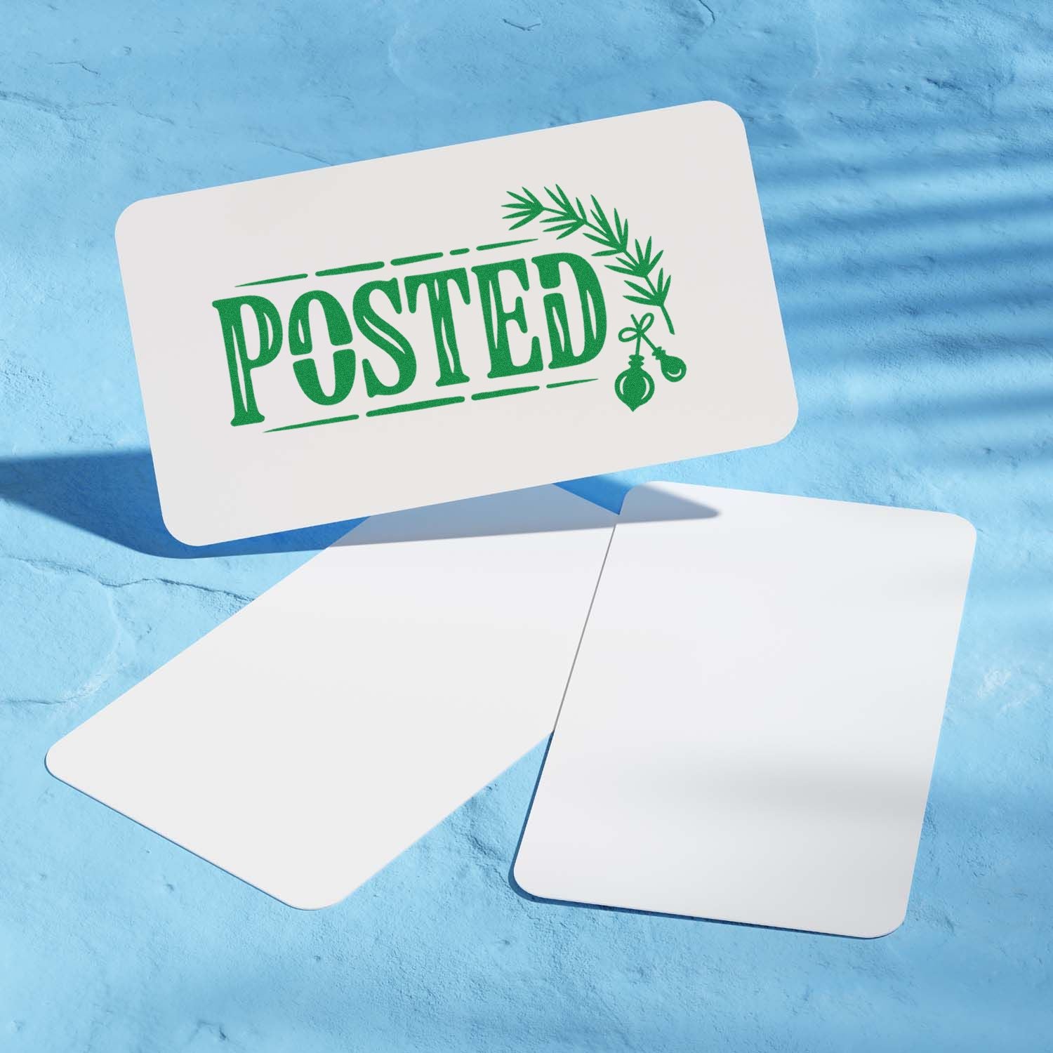 Green POSTED stamp and seal design with wreath ornaments on white cards over a blue background