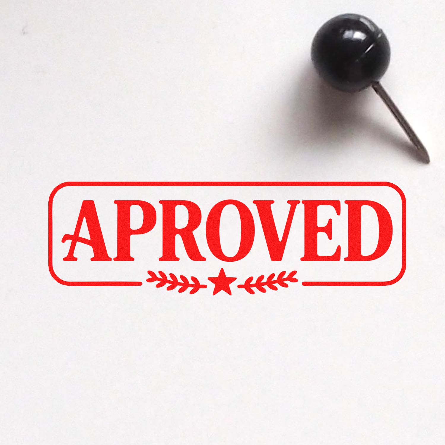 Red APPROVED rubber stamp and black seal pin on white background