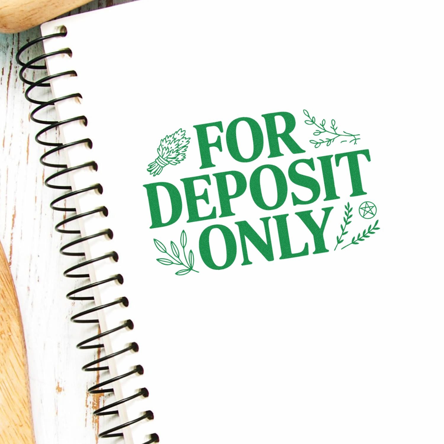 Green FOR DEPOSIT ONLY stamp and seal design with leaf accents on a spiral notebook page