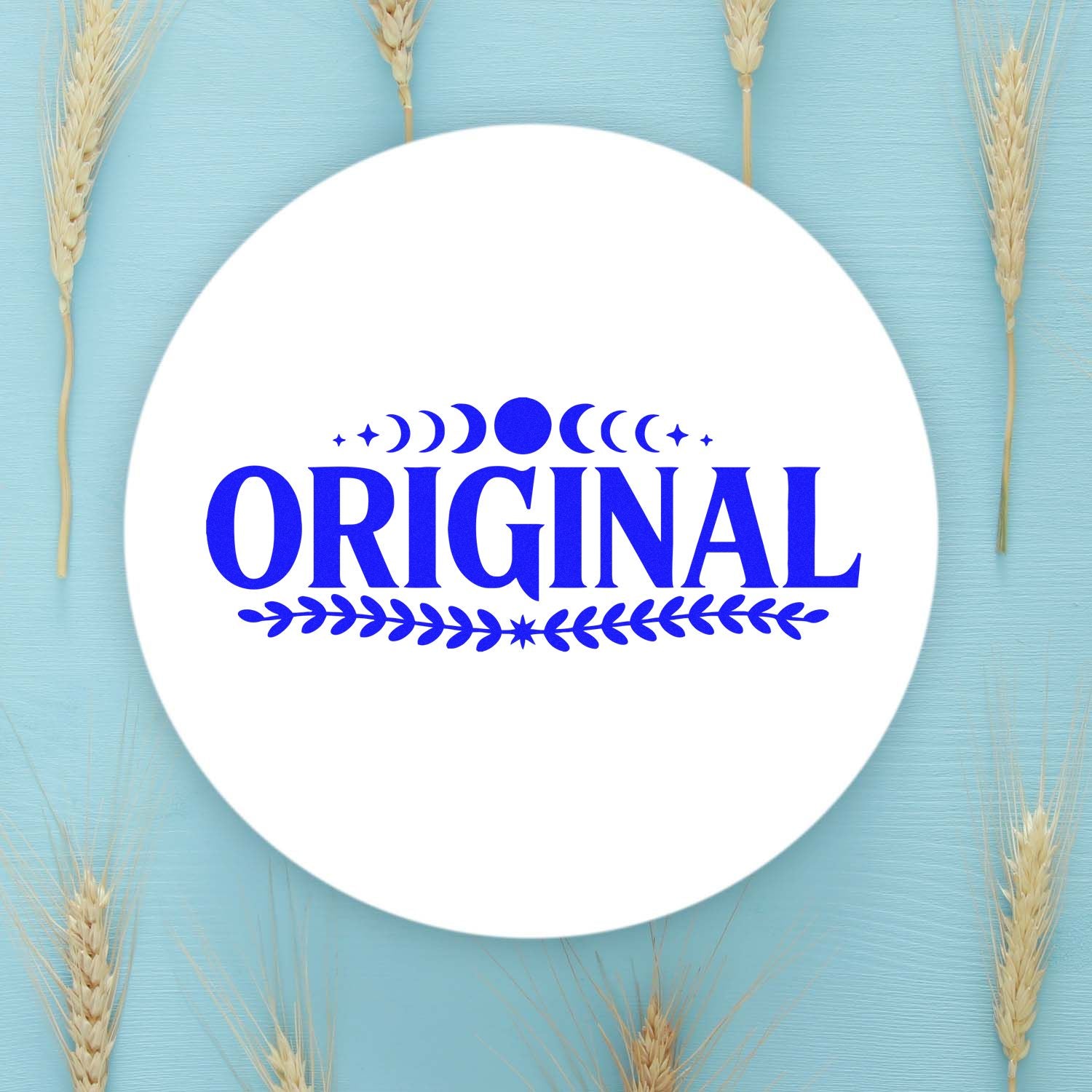 Blue original stamp seal on white circle with moon, stars and laurel accents, on light blue background with wheat stalks.