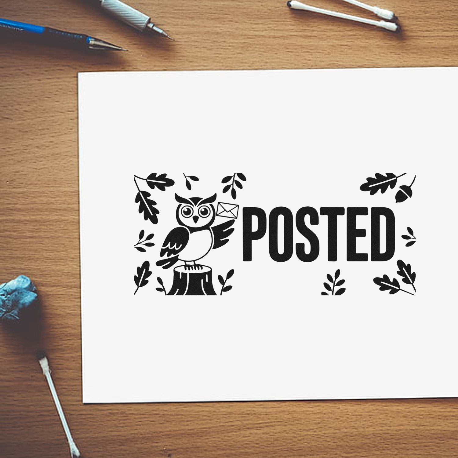 Black POSTED stamp and seal design with owl, leaves, and envelope on white paper.