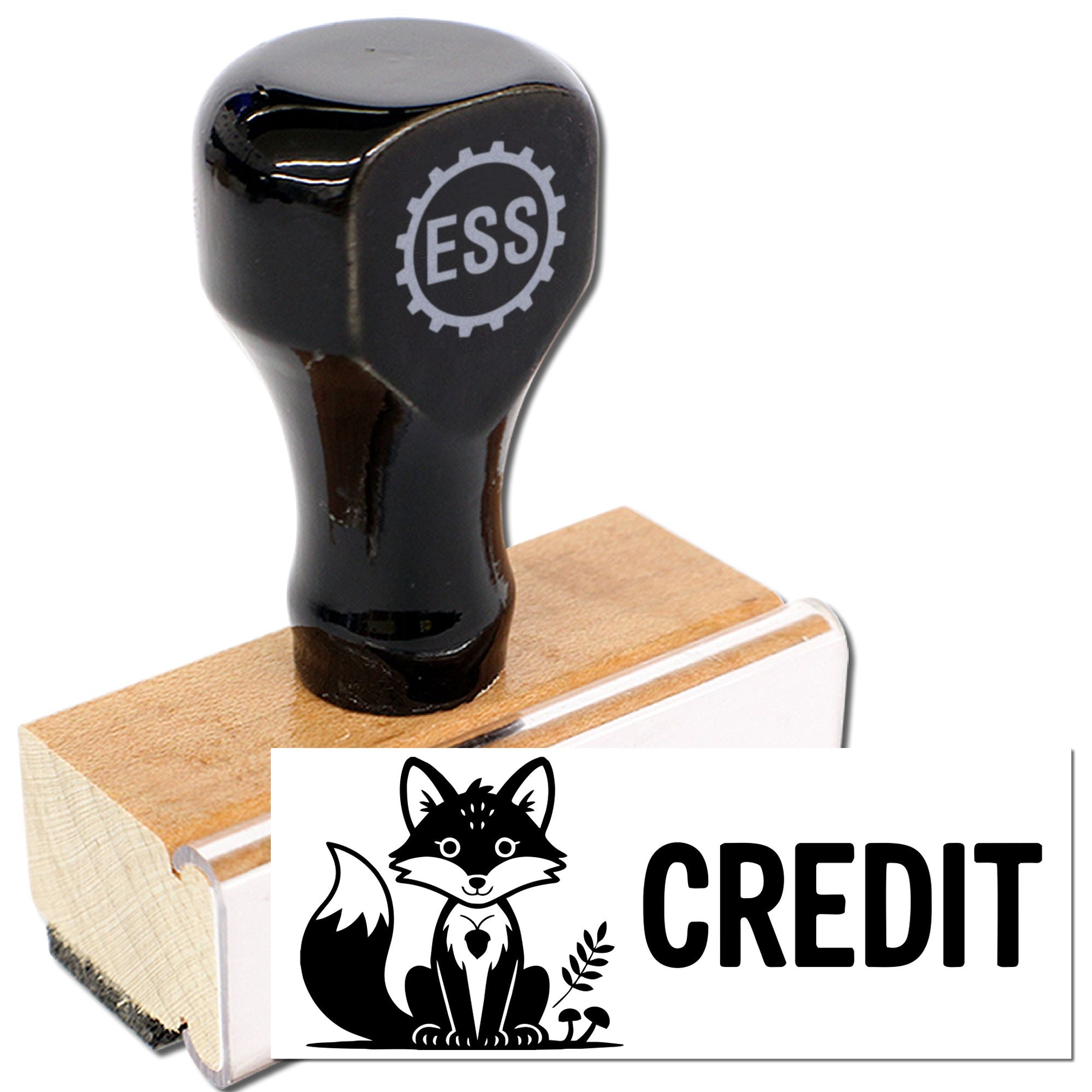Black ESS rubber stamp on tan wooden block, creating a white CREDIT seal with a black fox graphic.