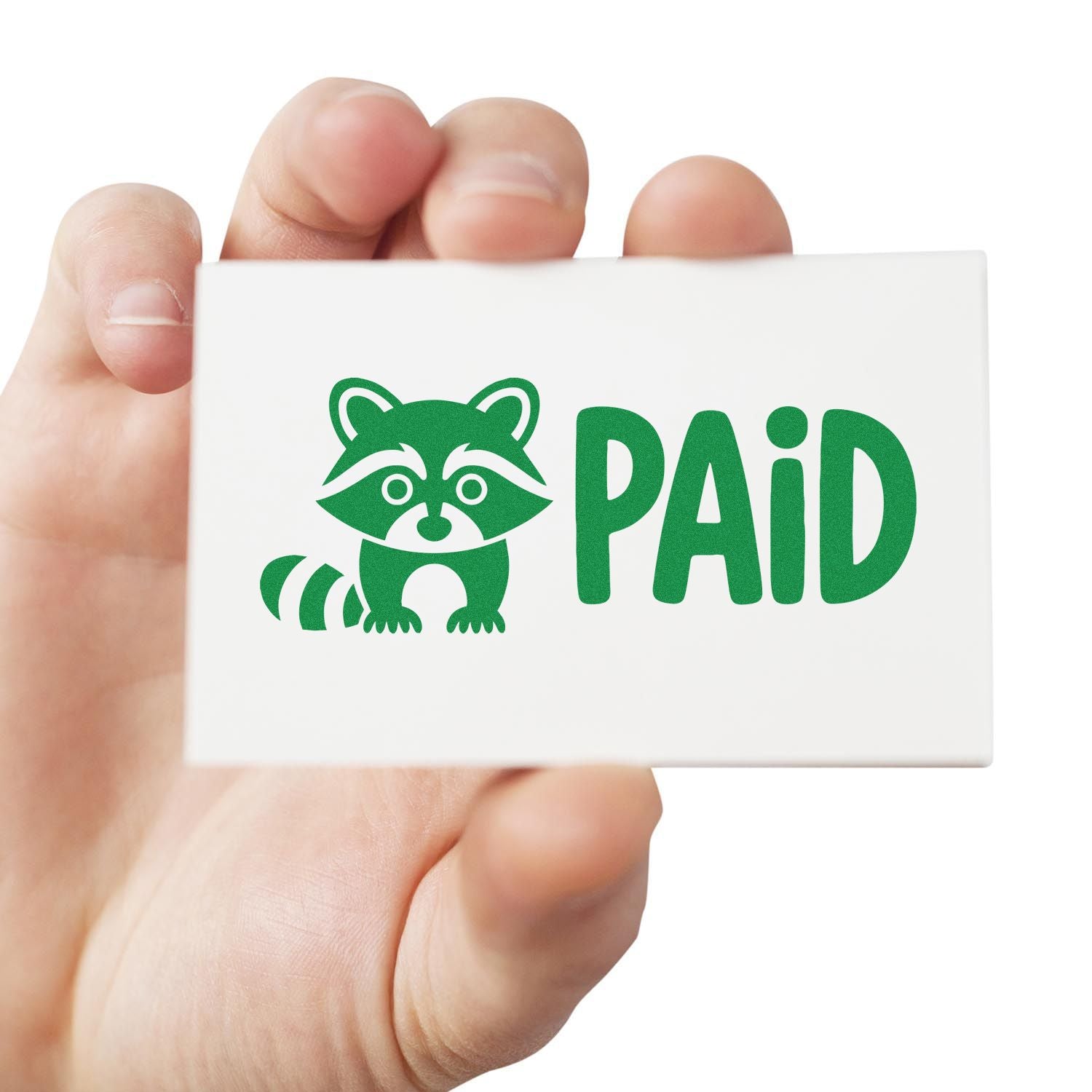 Hand holding white paid stamp card with green raccoon seal logo and bold PAID text.