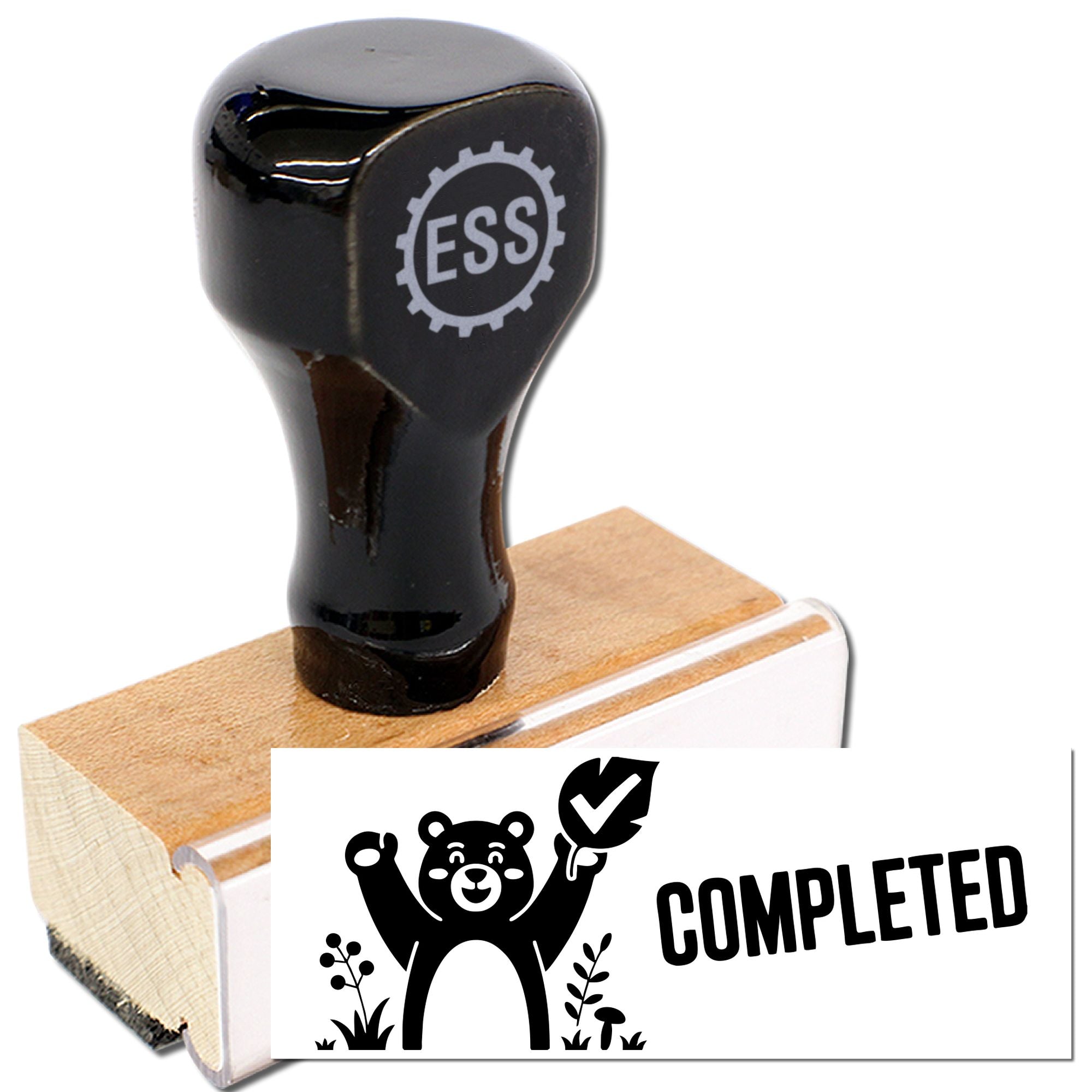 Black ESS rubber stamp on a wooden block, with a black-and-white bear COMPLETED seal design.