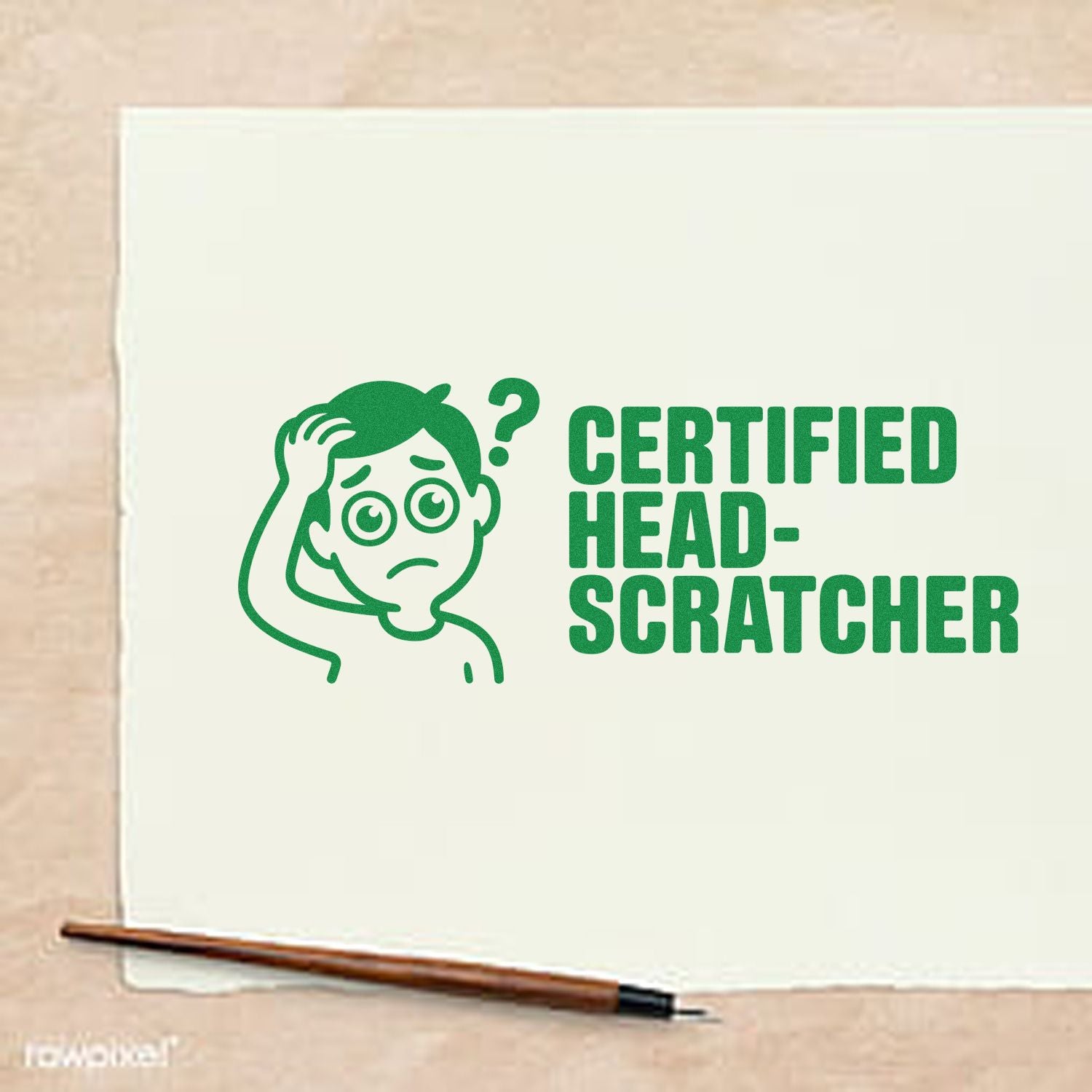 Green rubber stamp seal reading Certified Head-Scratcher with confused cartoon face on cream paper, brown-handled stamp tool below.