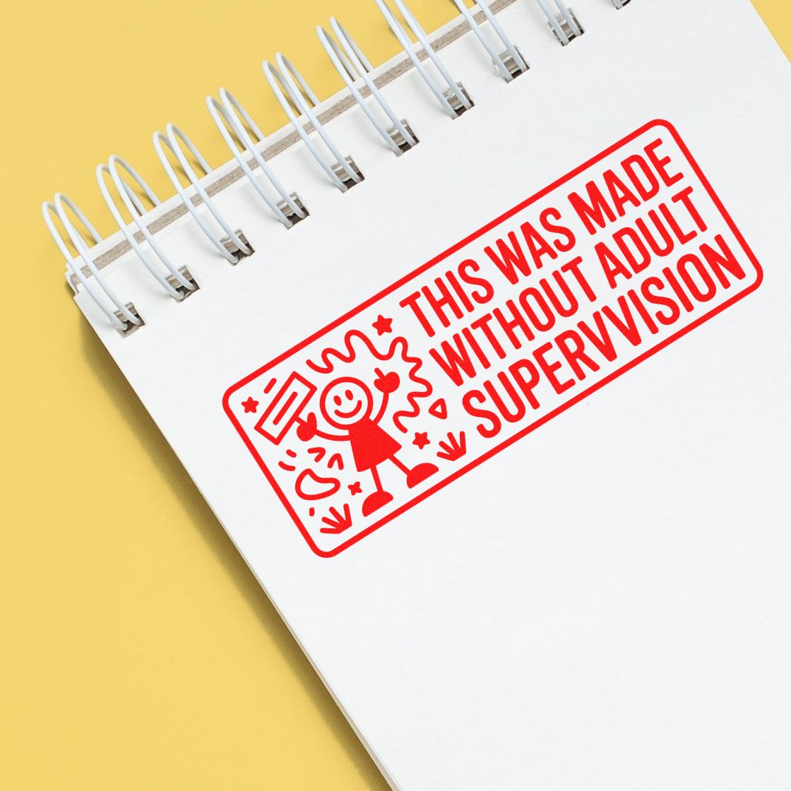 Red stamp and seal reading This was made without adult supervision on a white spiral notebook with yellow background.