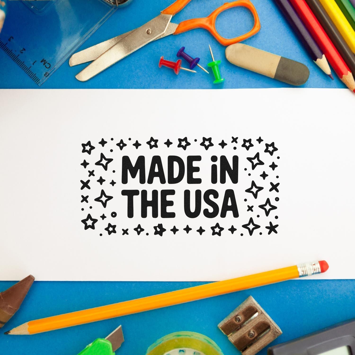 Black Made in the USA stamp and seal on white paper, surrounded by colorful school supplies on a blue background.