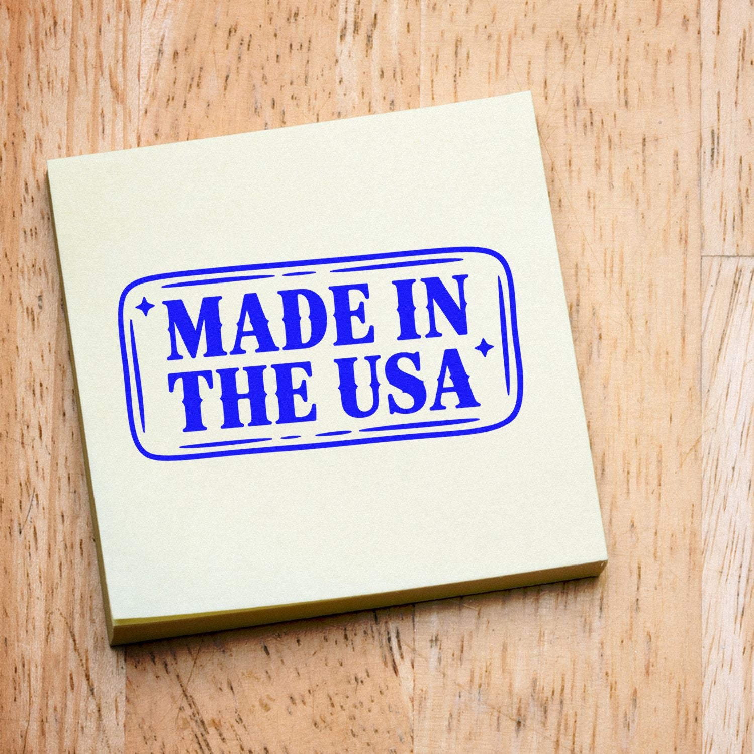 Blue Made in the USA stamp and seal block on cream paper over a light wood background.