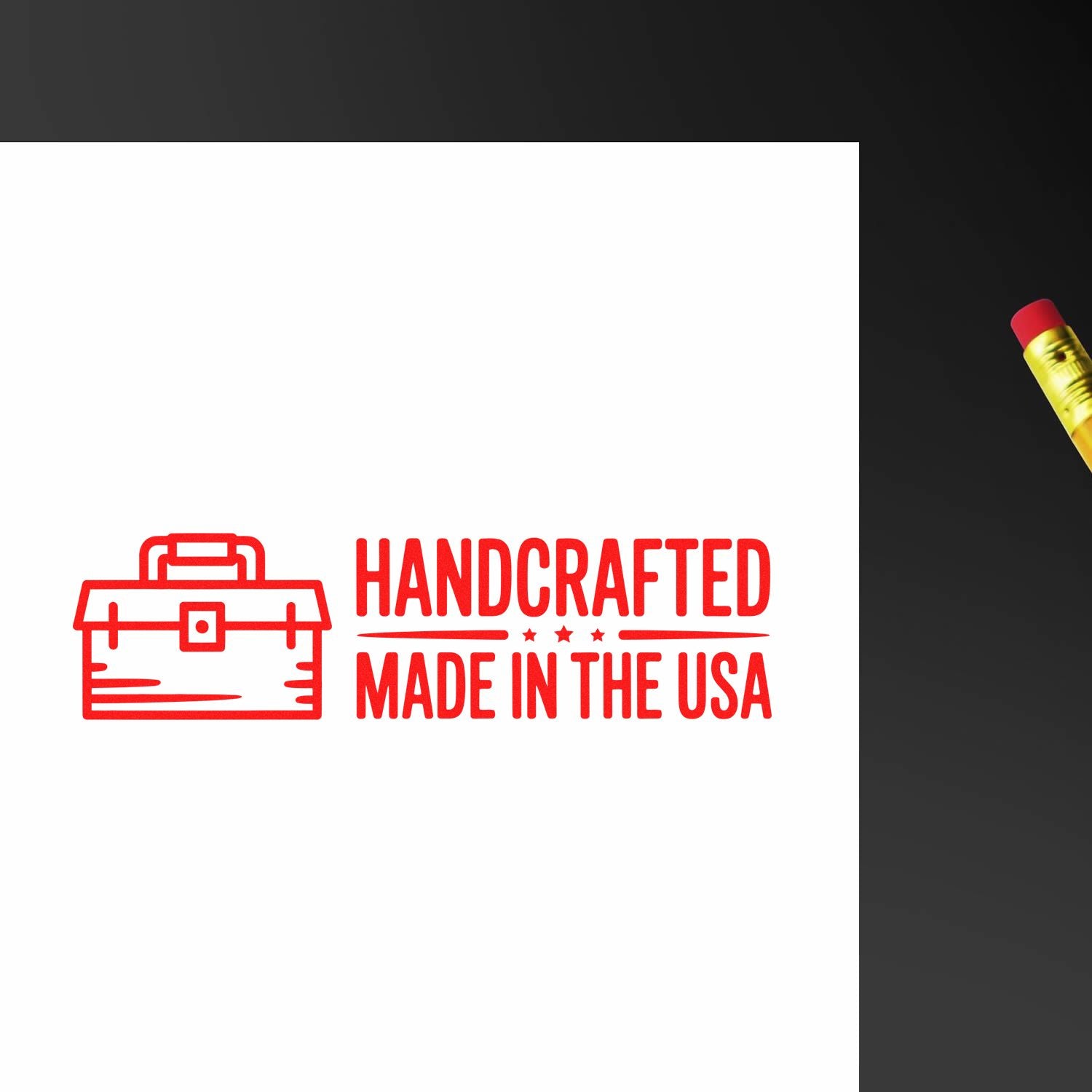 Red handcrafted Made in the USA stamp seal with toolbox icon on white paper, pencil at right