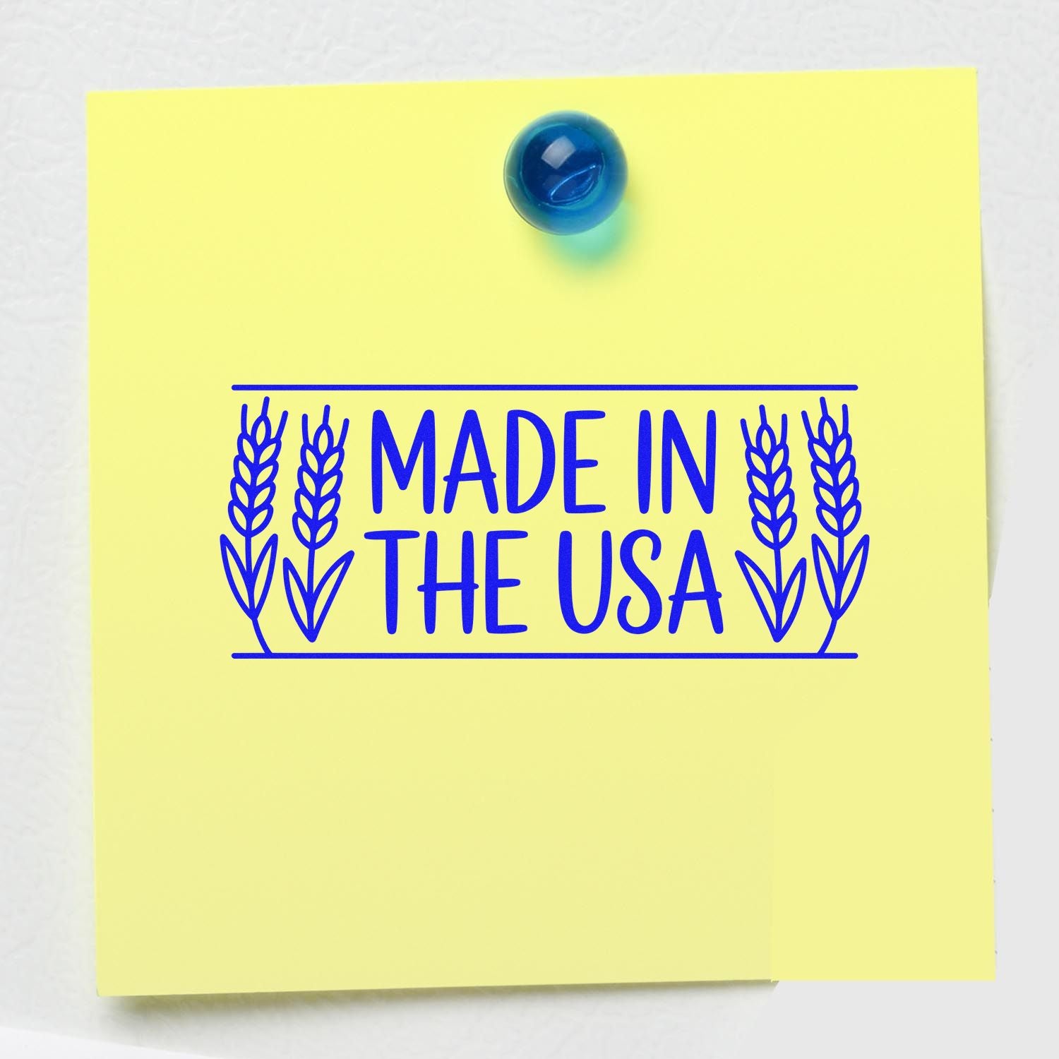 Blue Made in the USA stamp seal on a pale yellow note with wheat borders and a blue pushpin.