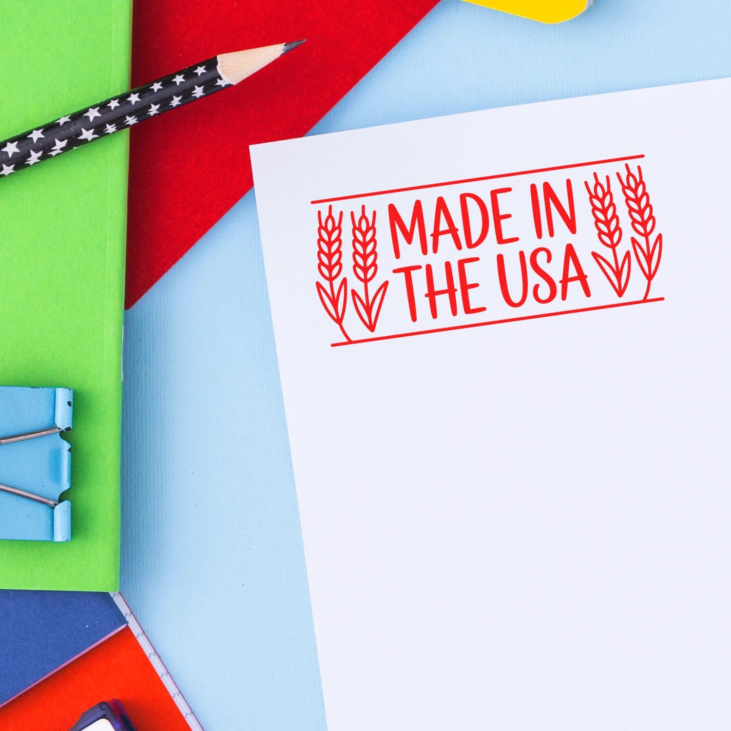 Red Made in the USA stamp and seal on white paper, with colorful stationery and a star-pattern pencil.