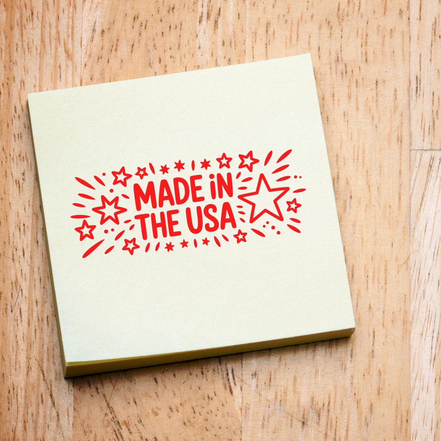 Cream stamp pad with red Made in the USA seal and starburst design on a wood surface.