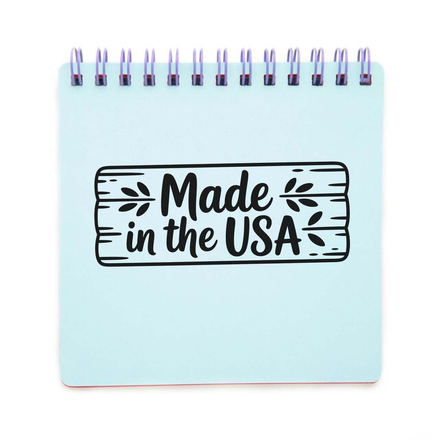 Light blue spiral notebook with a black Made in the USA wood-sign style stamp and seal graphic.