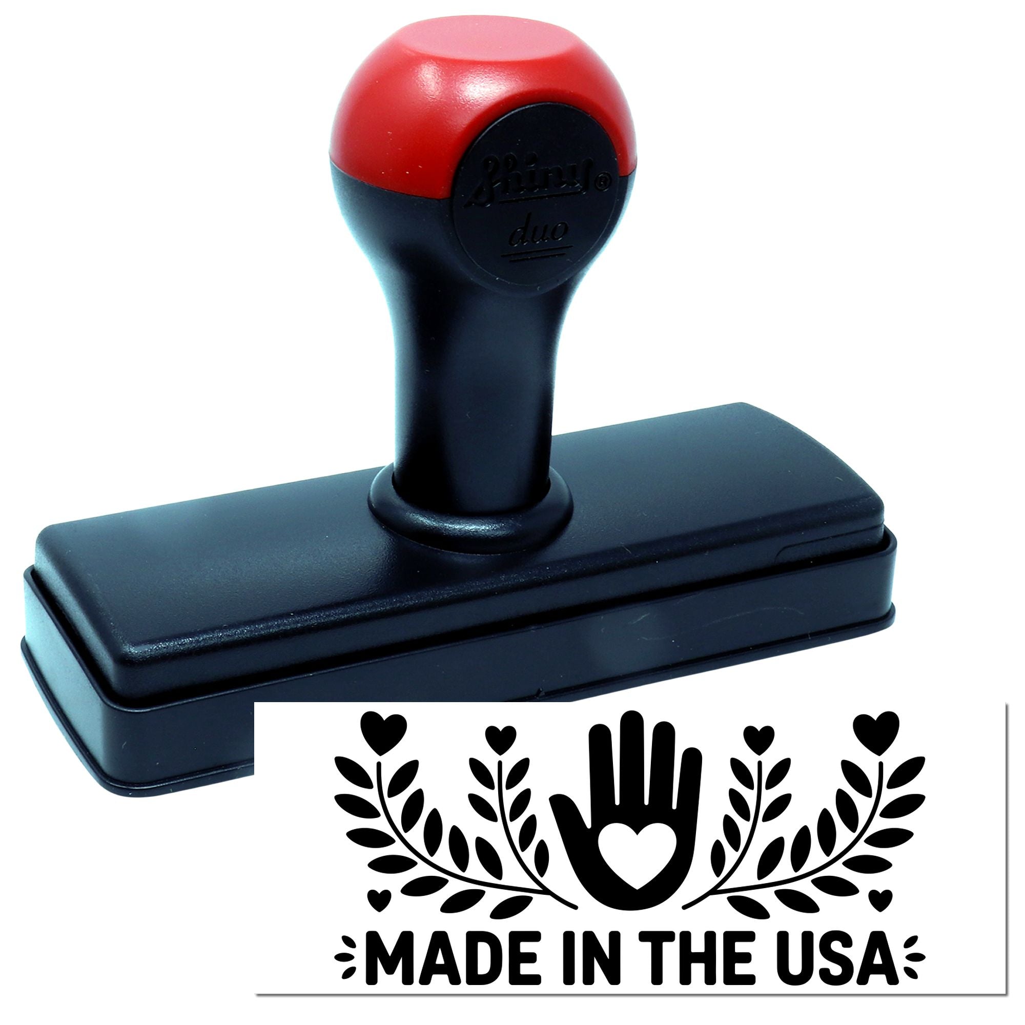 Red-and-black self-inking stamp with rectangular base and Made in the USA seal design.
