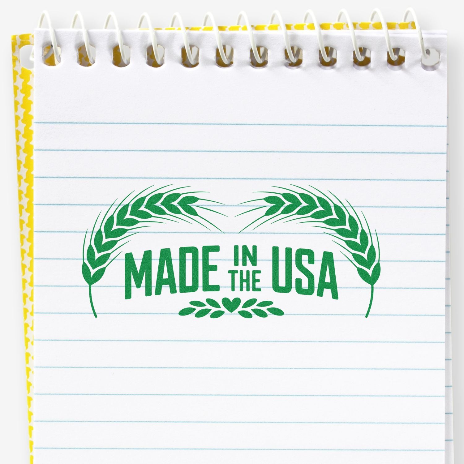 Green Made in the USA stamp and seal with laurel wreath on a white lined notebook page